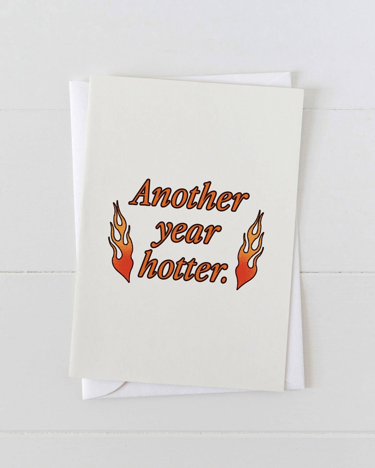Greeting card with 'Another year hotter.' text and flames on a white background