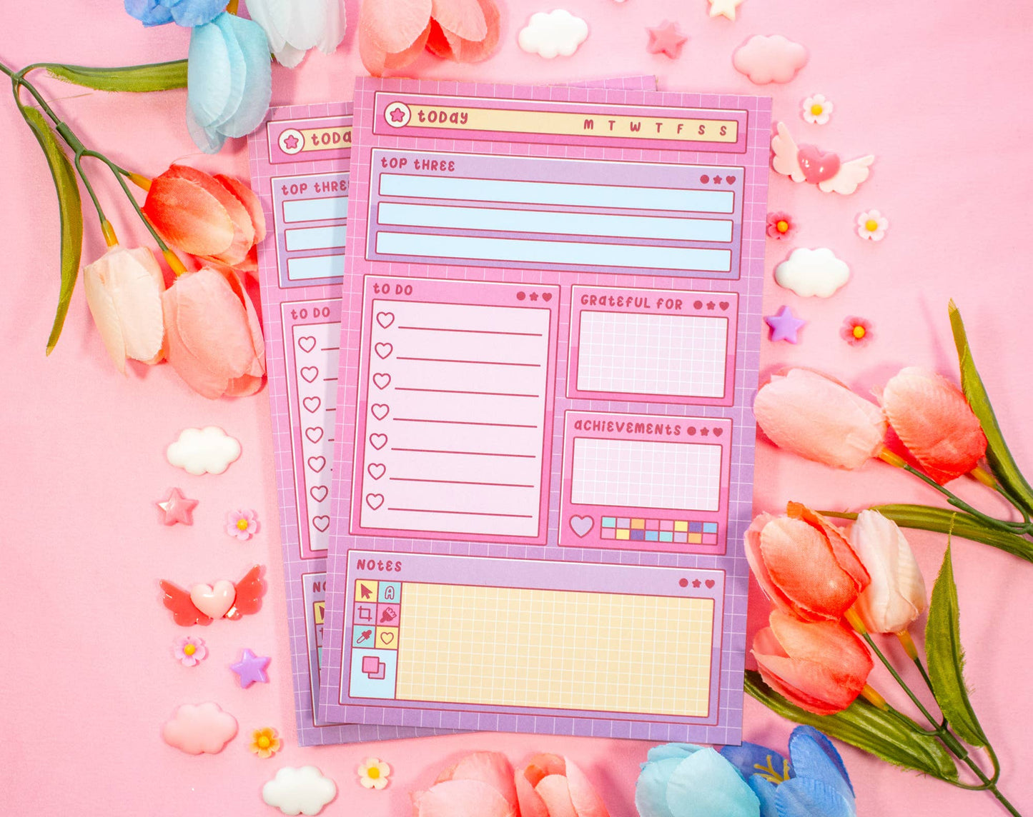 Set of planner stickers with various designs on a pink background with flowers