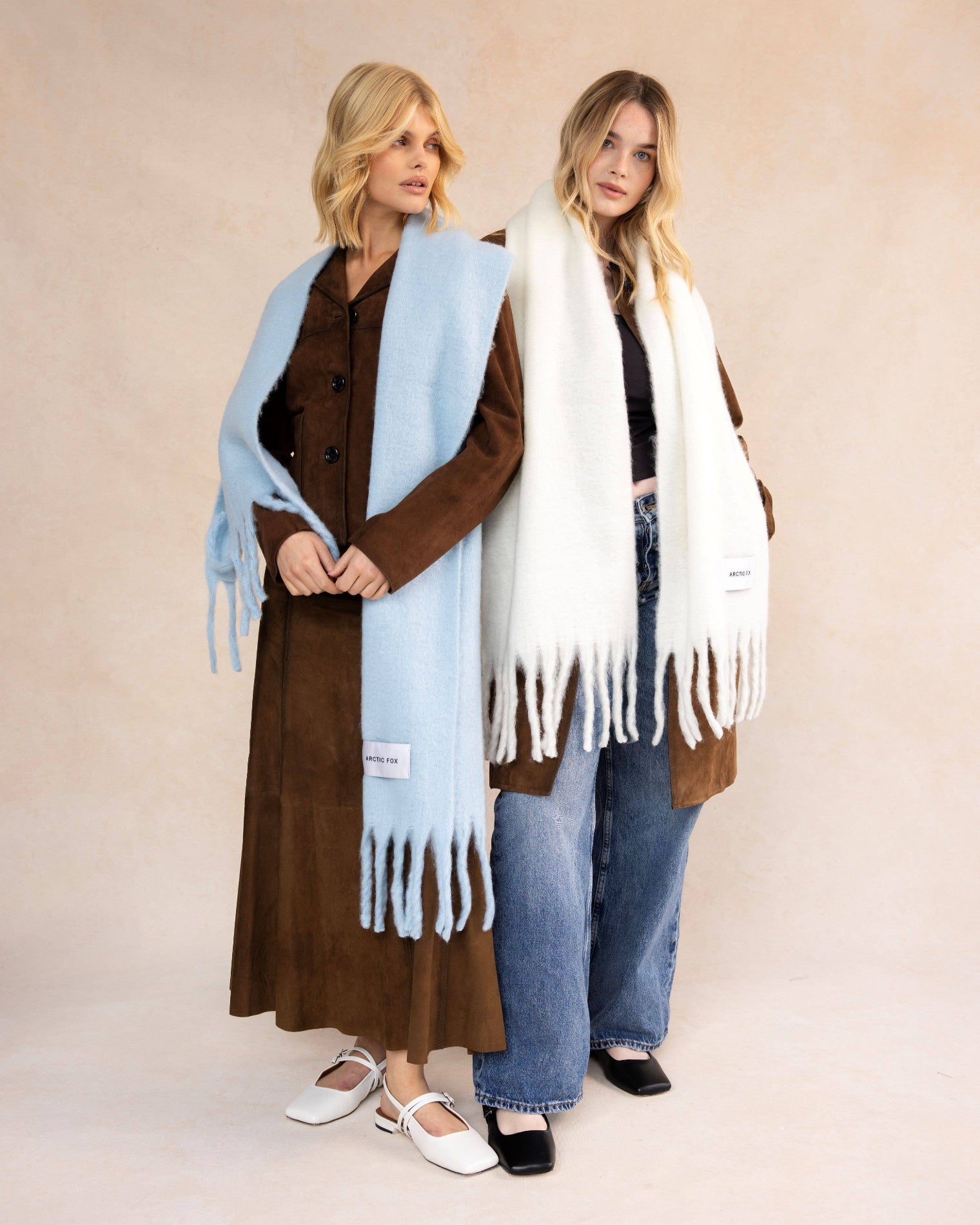 Two women wearing long scarves against a beige background, Baby Blue Recycled Bottle Stockholm Scarf