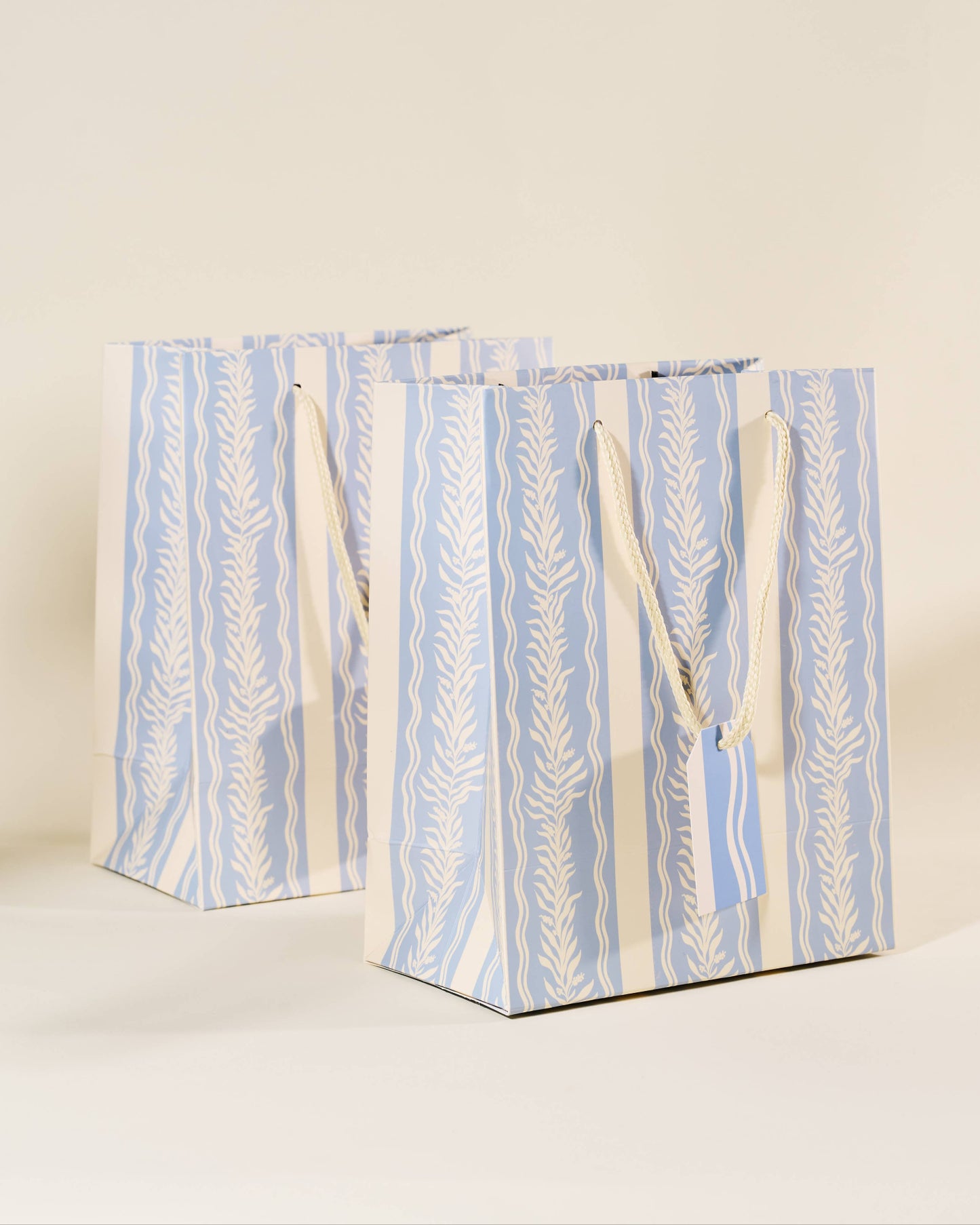 Two blue and white patterned gift bags on a beige background, Blue Vine Medium Paper Gift Bag