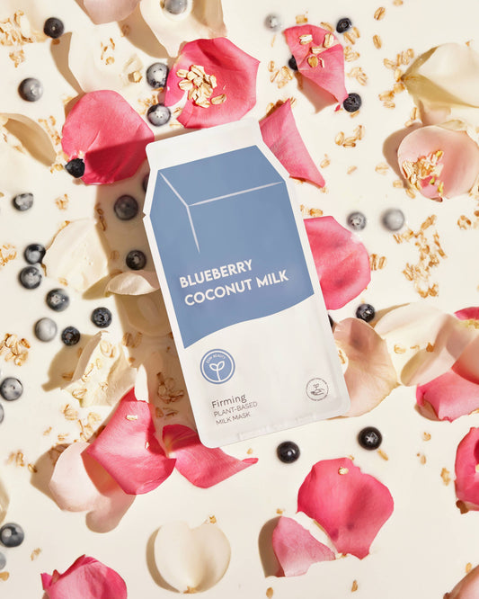 Blueberry Coconut Milk packaging with floral and berry background Blueberry Coconut Milk Firming Sheet Mask
