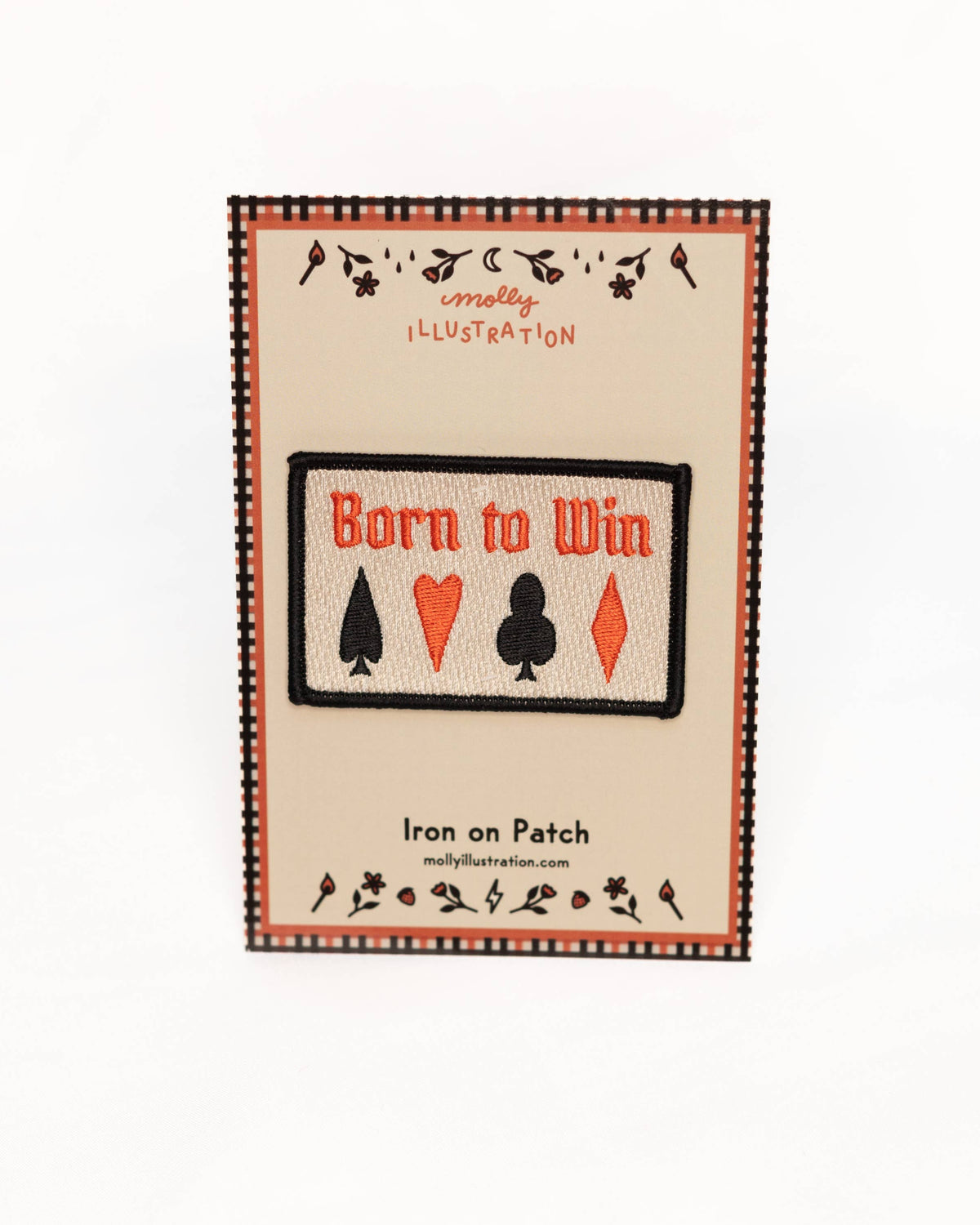 Patch with 'Born to Win' text and card suit symbols on a beige background