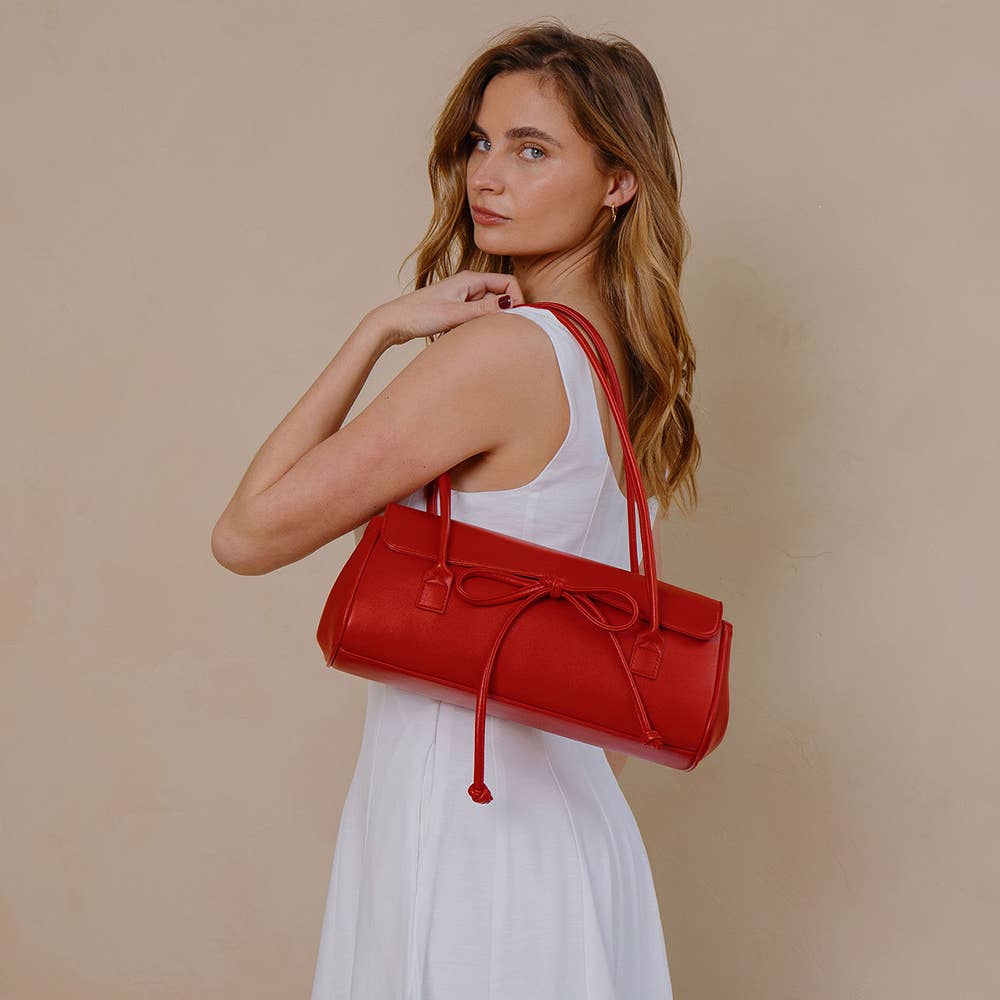 Woman holding a red handbag against a beige background, Bowie Shoulder Bag, Melie Bianco