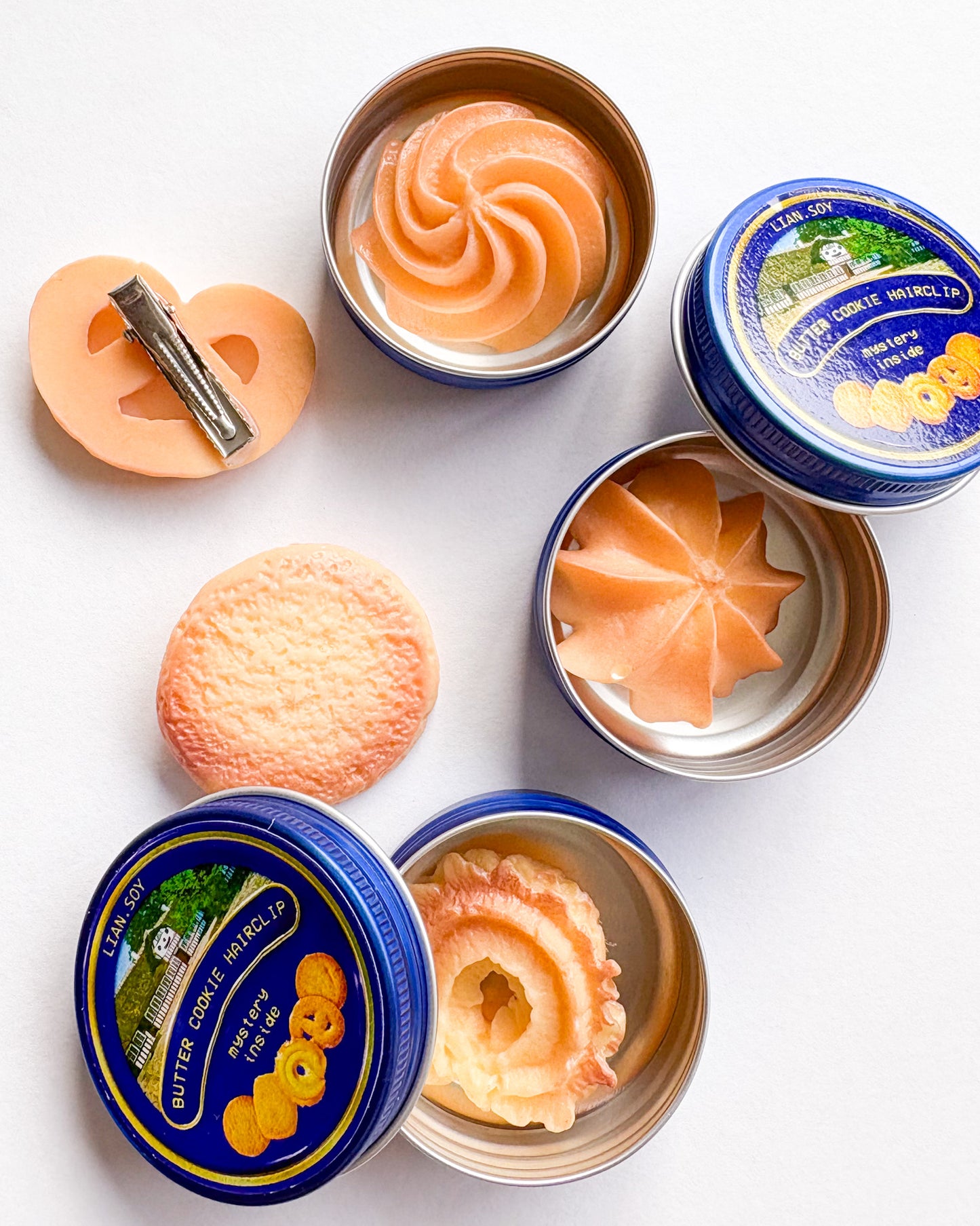 Butter cookies in tins on a white background