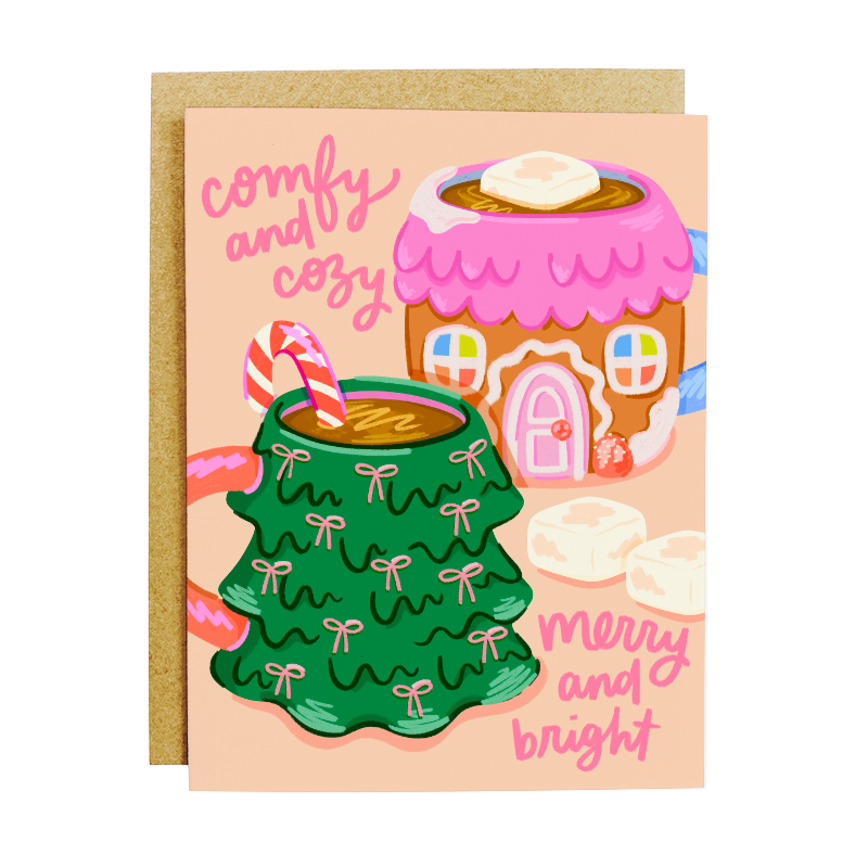 Greeting card with Christmas-themed illustrations of a green mug, pink gingerbread house, and candy canes on a peach background.