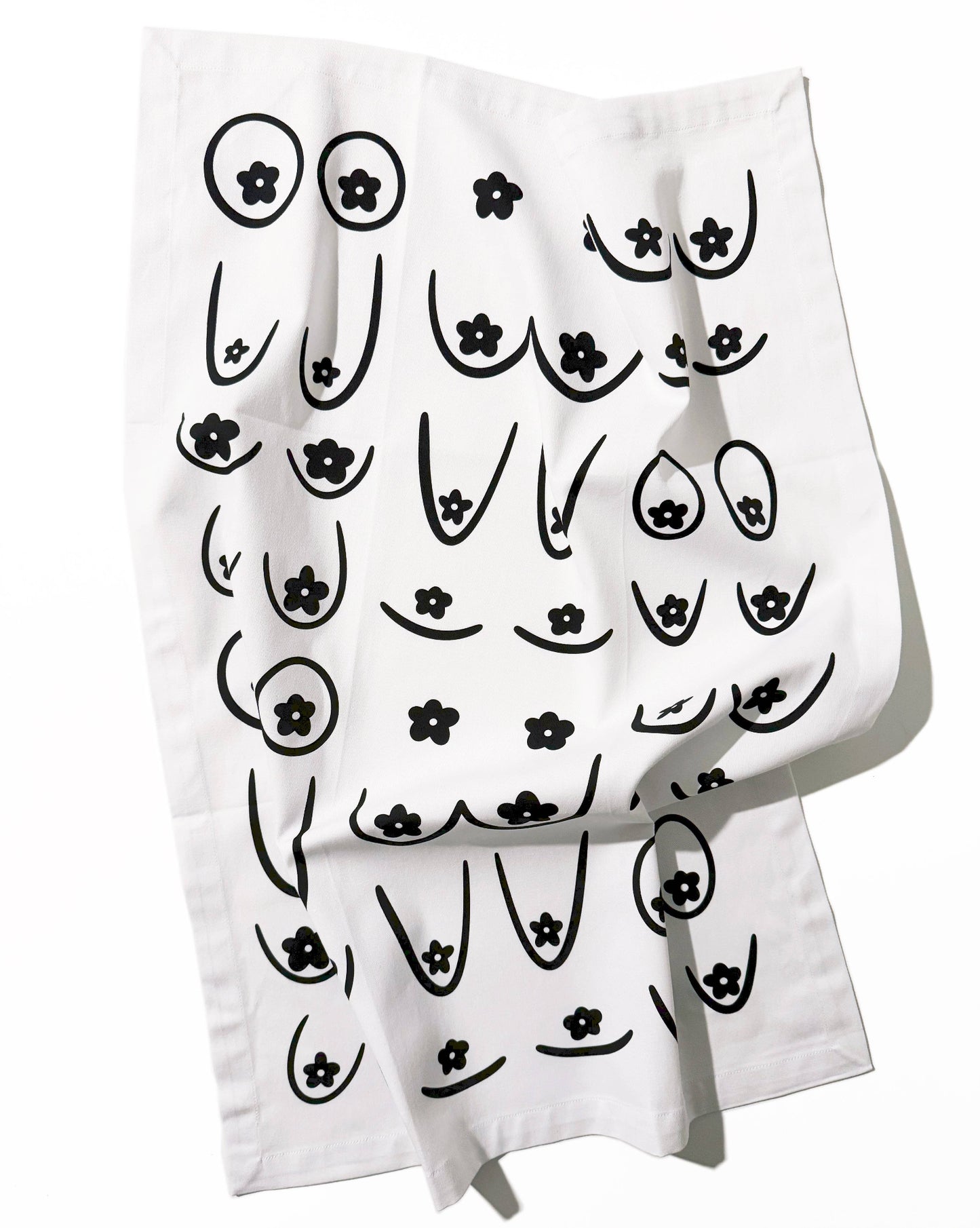White towel with black abstract designs on a white background, Daisy Boob Kitchen Tea Towel