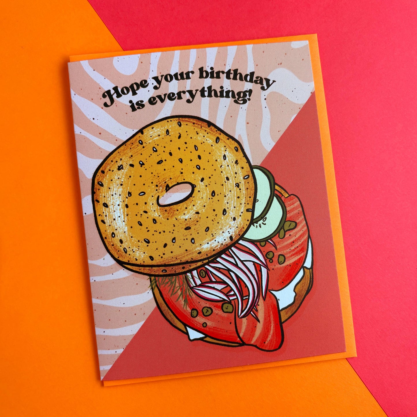 Greeting card with a bagel sandwich illustration and text on a colorful background