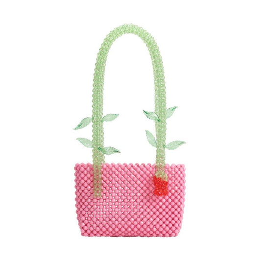 Melie Bianco Flor Pink Beaded Rose Shoulder Bag Pink beaded handbag with green beaded handles and a red flower on a white background
