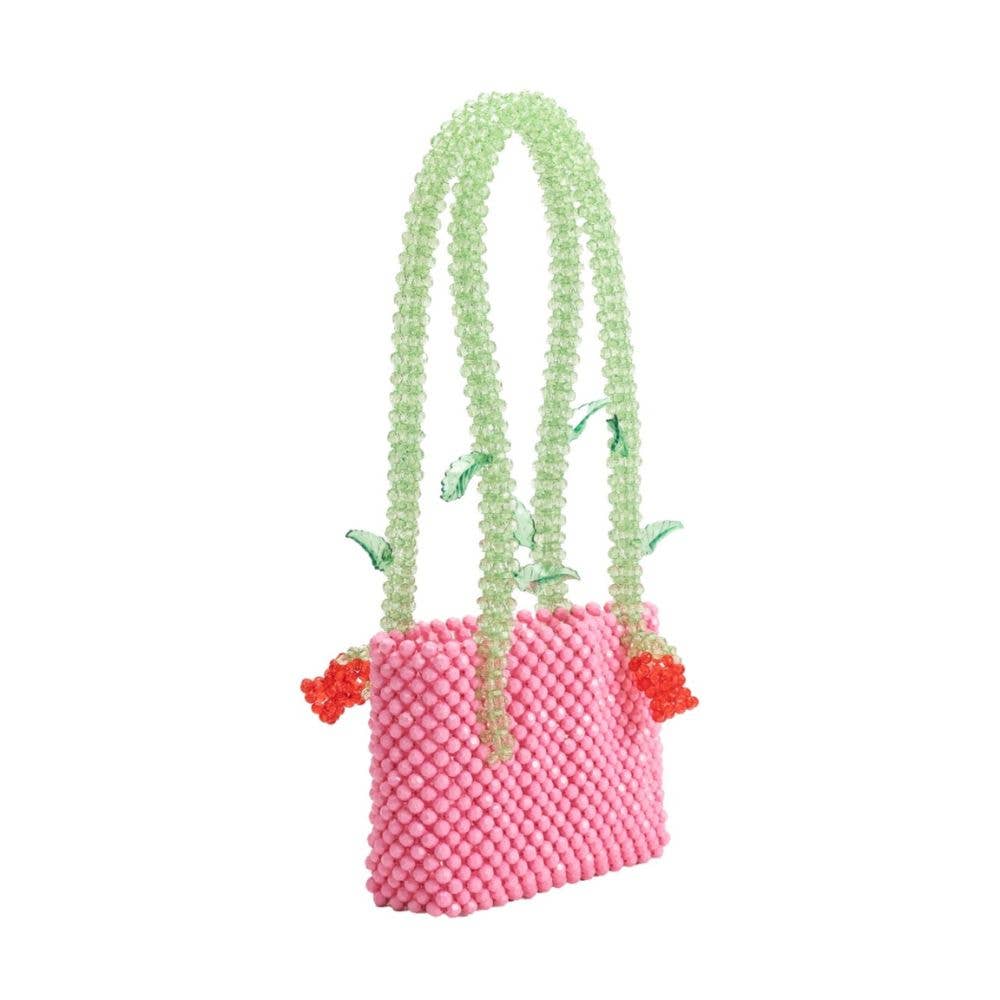 Melie Bianco Flor Pink Beaded Rose Shoulder Bag Pink beaded bag with green handle and red flowers on a white background
