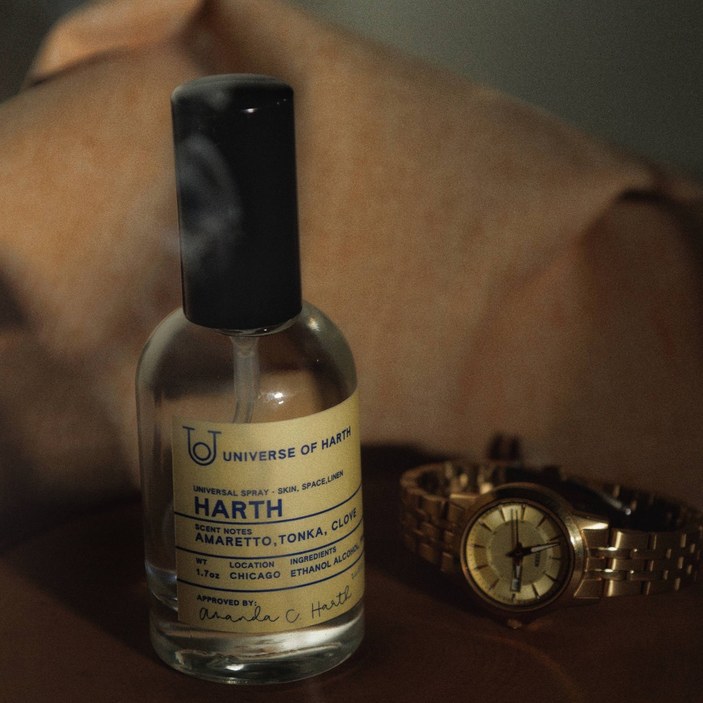 Bottle of Harth product with a gold watch on a wooden surface, Harth: Room, Space and Body Spray