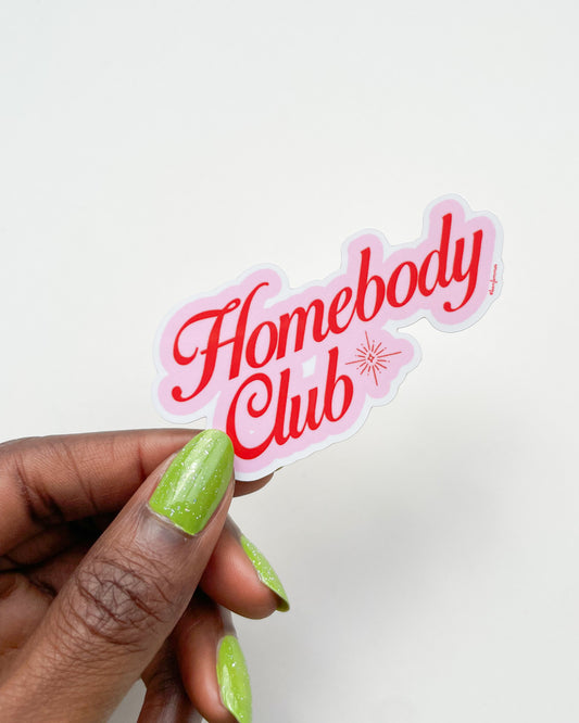 Hand holding a 'Homebody Club' sticker with pink border and red text on a white background, Homebody Club Sticker Bon Femmes