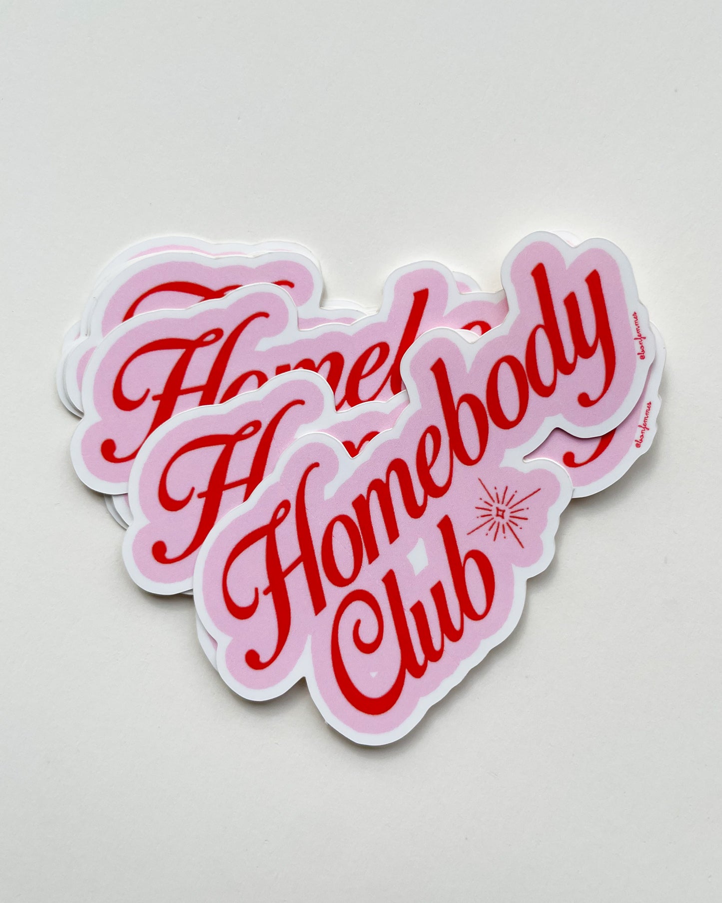 Sticker with 'Homebody Club' text in pink and red on a light gray background, Homebody Club Sticker Bon Femmes
