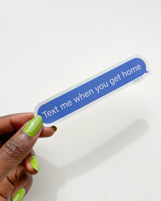 Hand holding a blue text message bumper sticker with 'Text me when you get home' on a white background, Text Me When You Get Home Text Bubble Sticker