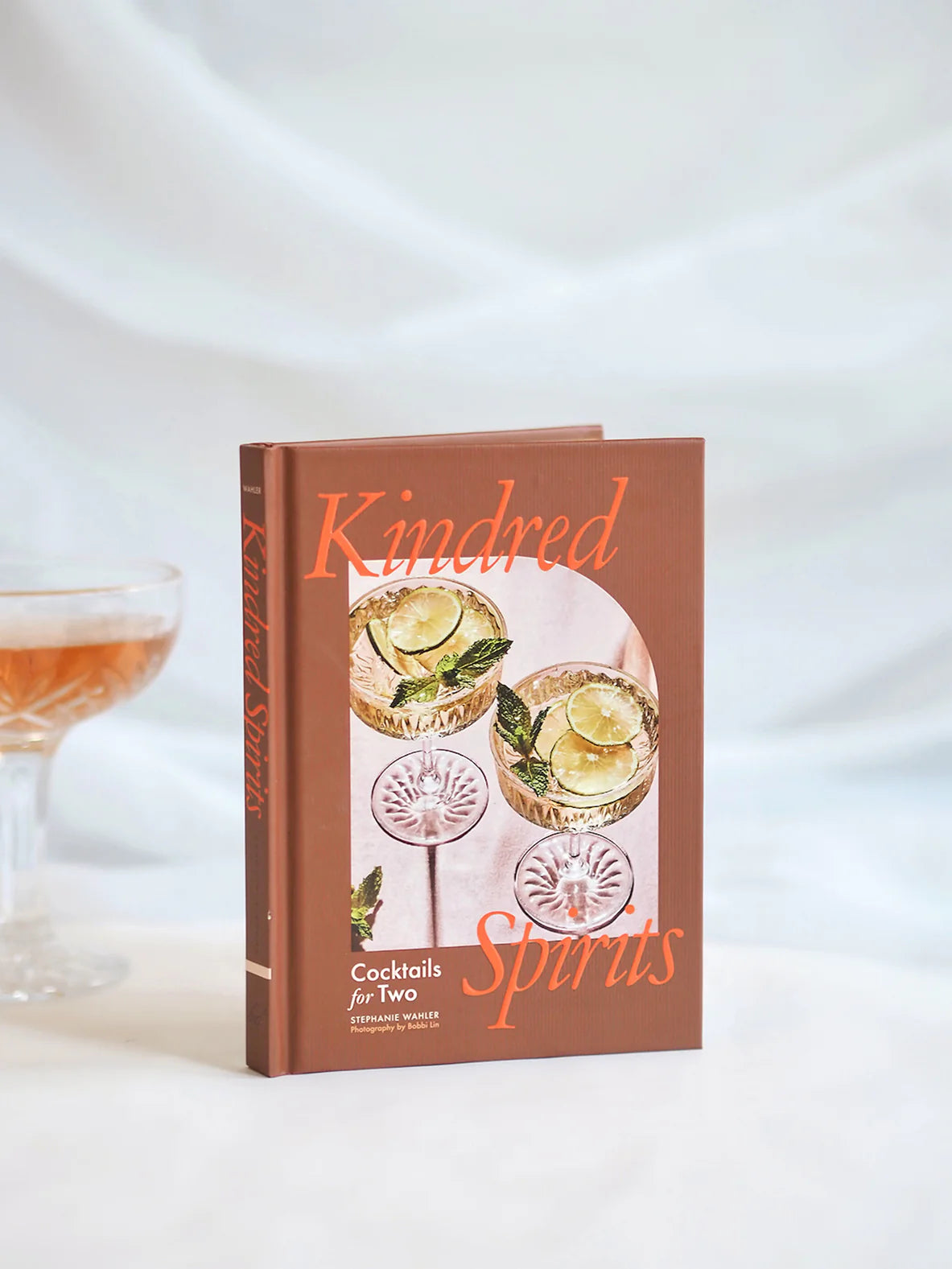 Cookbook titled 'Kindred Spirits' with cocktail illustrations on a white background