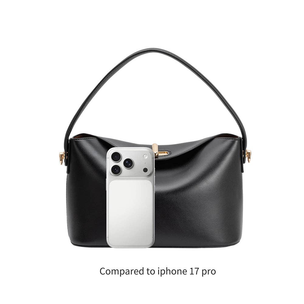 Black handbag with a phone inside, compared to an iPhone 17 Pro on a white background