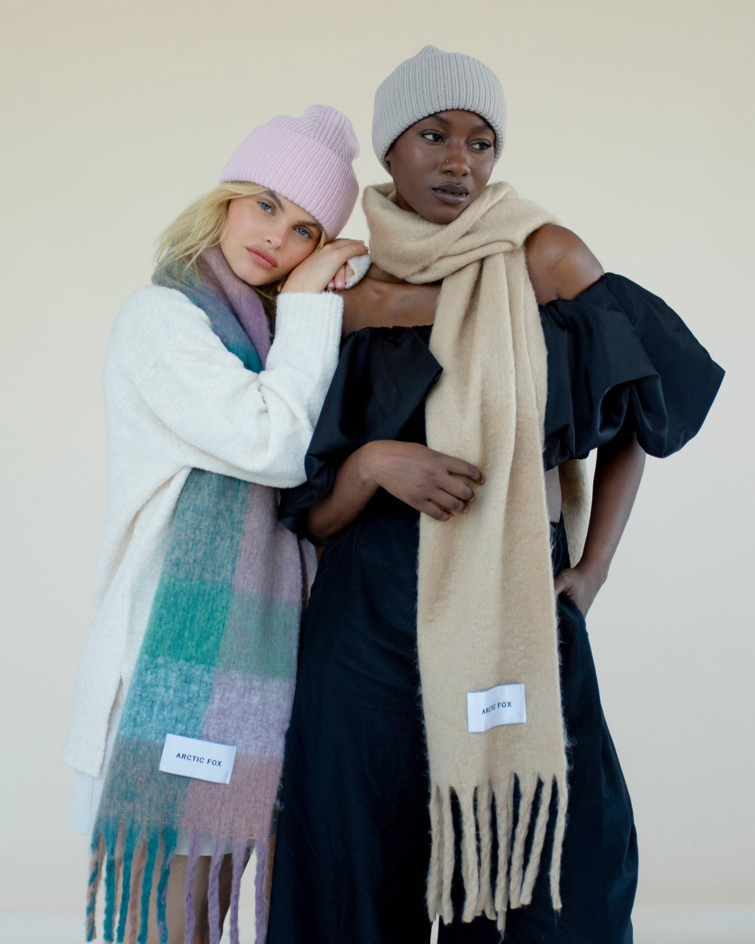 Two women wearing scarves and hats against a plain background, Lilac Check Recycled Bottle Reykjavik Scarf