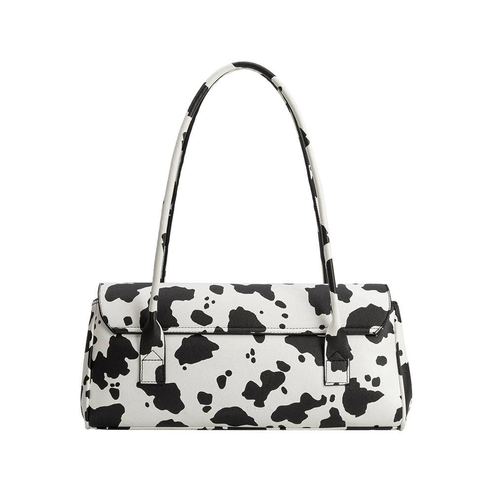 Black and white cow print handbag on a white background, Melie Bianco Bowie Cow Print Shoulder Bag