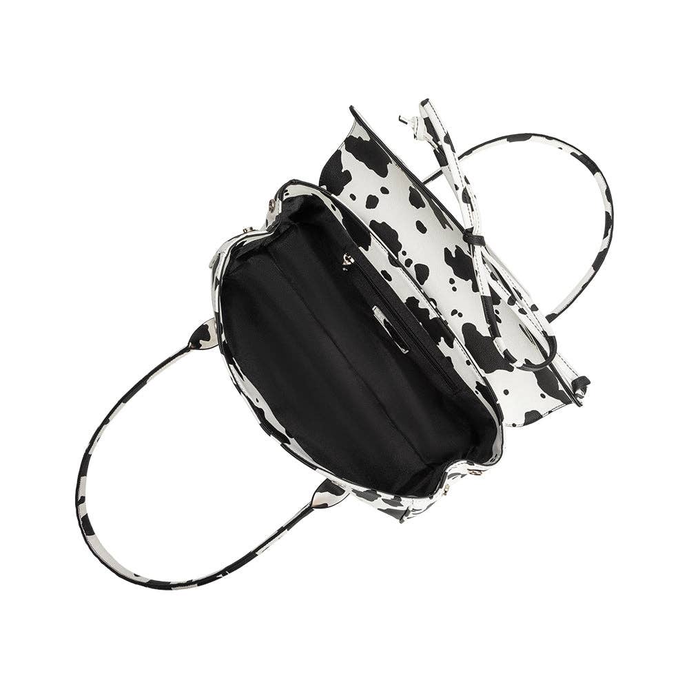 Black handbag with a white and black patterned interior on a white background. Melie Bianco Bowie Cow Print Shoulder Bag