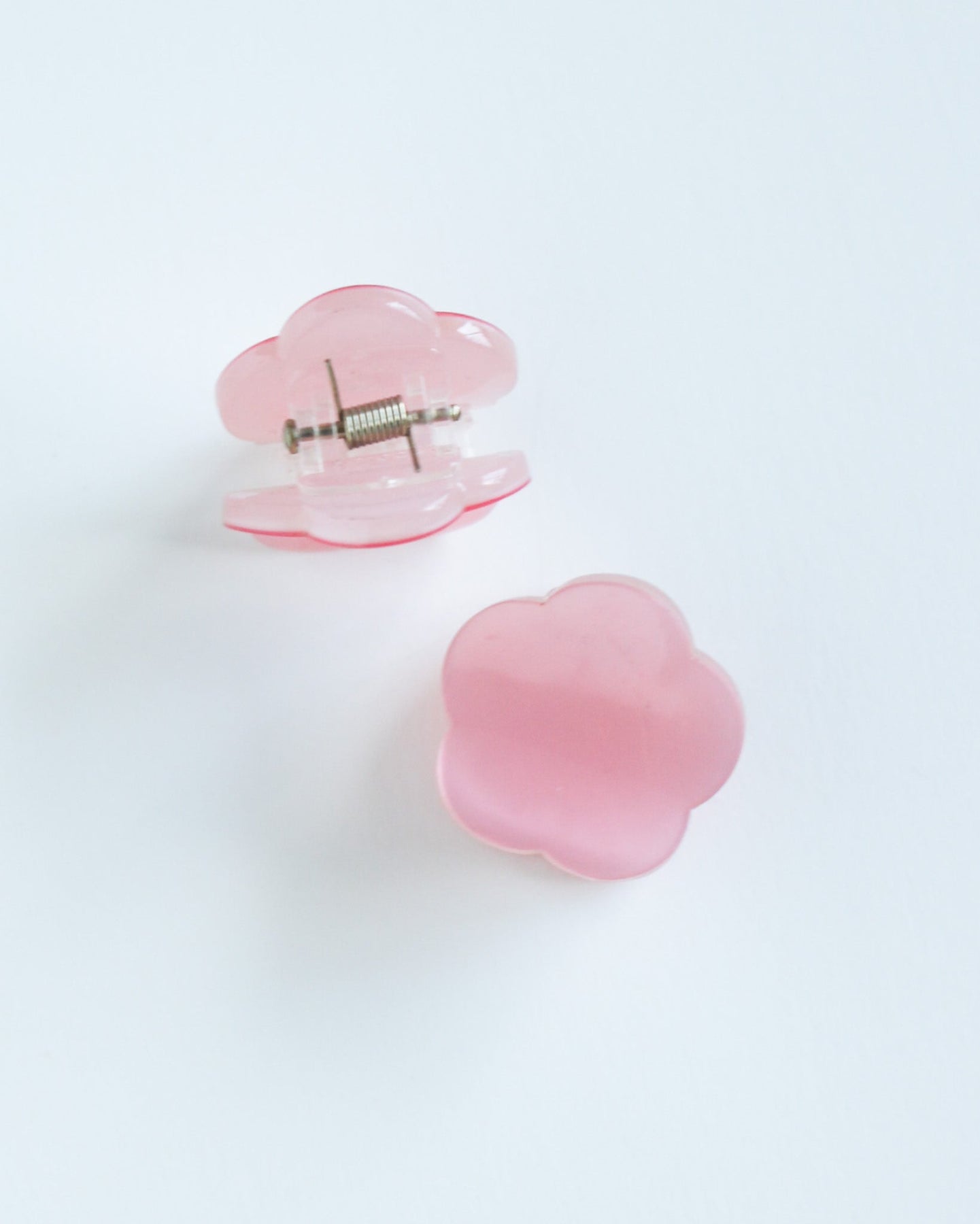 Mini Daisy Hair Claw Clip Two pink flower-shaped objects on a white background