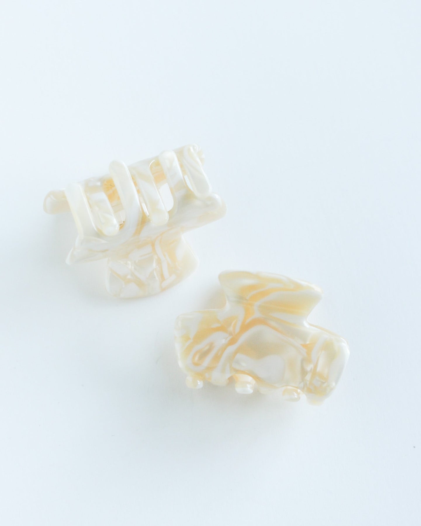 Mini Hair Claw Clip Two white hair clips on a white background