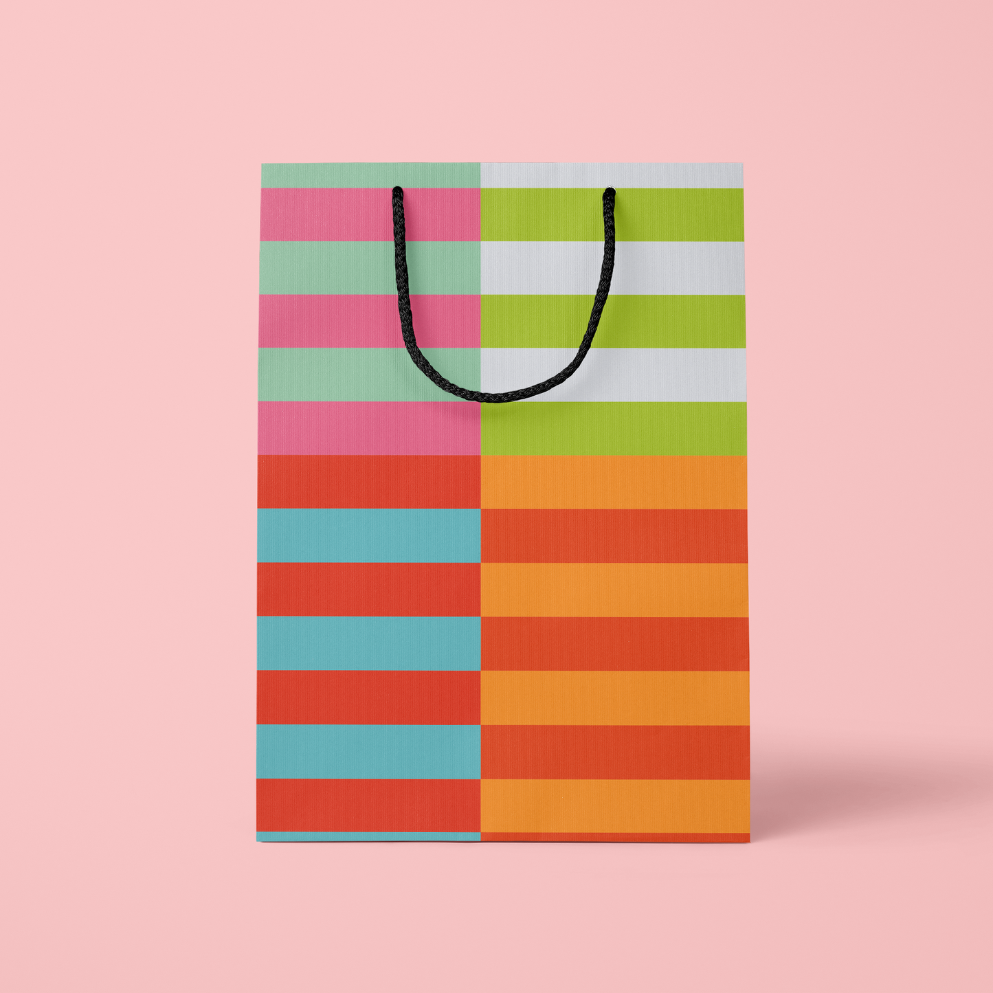 Colorful striped shopping bag on a pink background