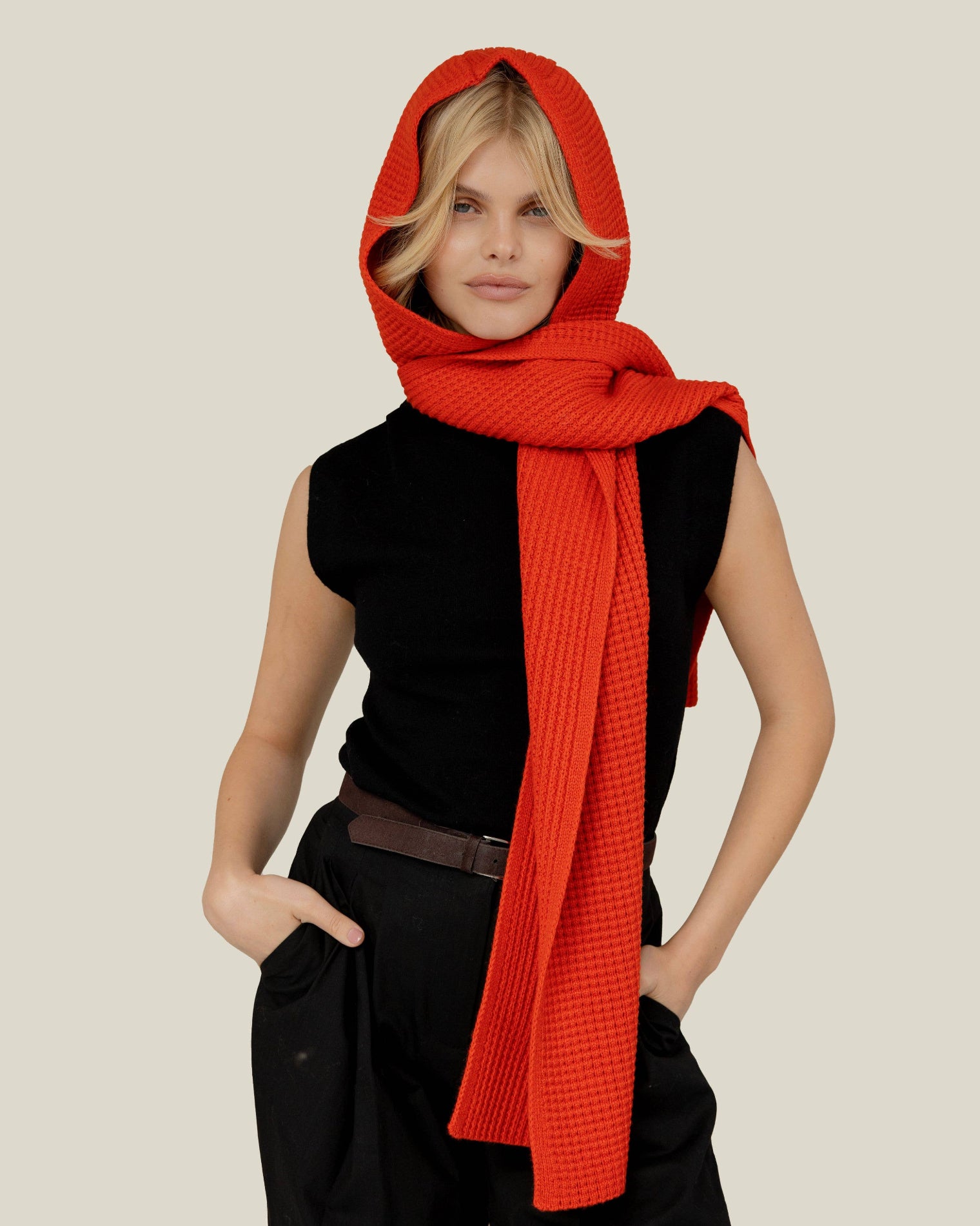 Person wearing a bright red scarf over their head against a plain background, Orange Recycled Bottle Hooded Scarf