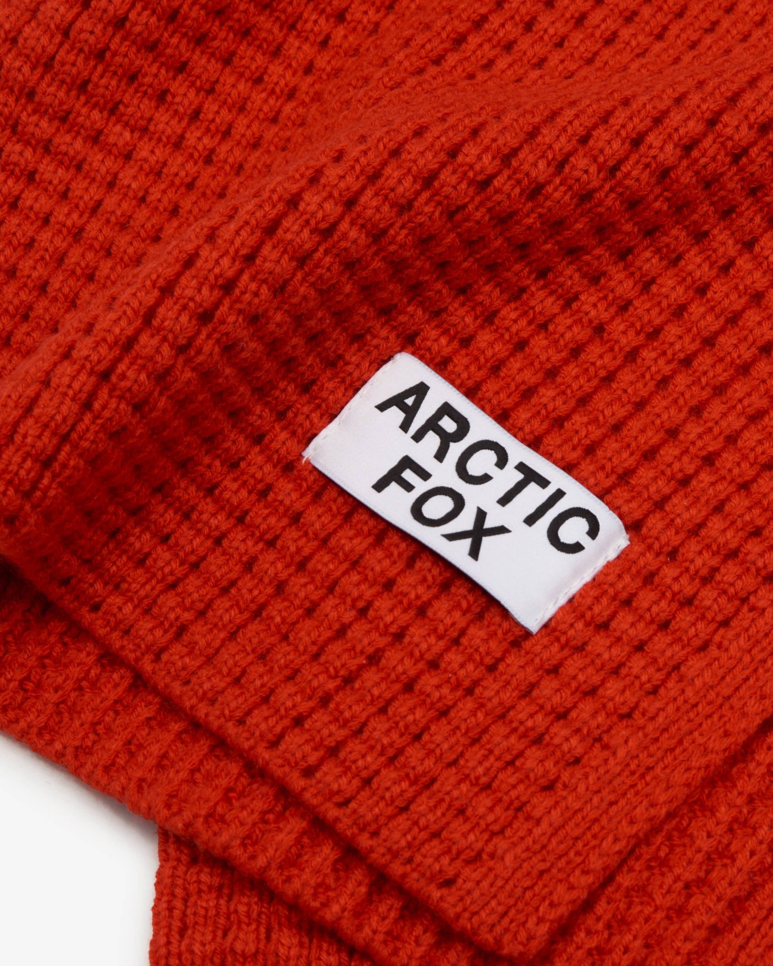 Red knitted item with 'Arctic Fox' label on a white background, Orange Recycled Bottle Hooded Scarf