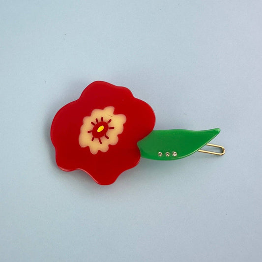 Floral hair clip with red flower and green leaf on a light blue background, Red Flower Hair Clip