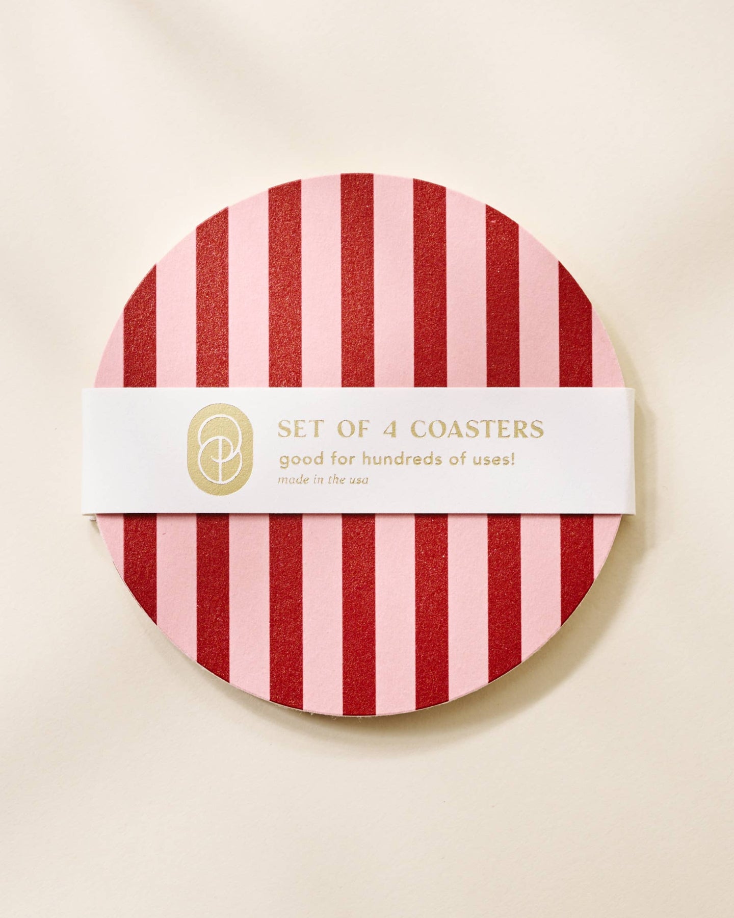 Set of 4 coasters packaging with red and pink stripes on a beige background