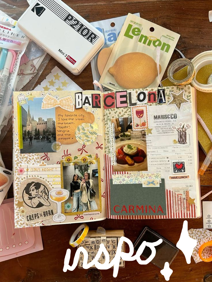 Scrapbook page with 'Barcelona' and 'Carmina' text, surrounded by stationery items on a wooden surface.