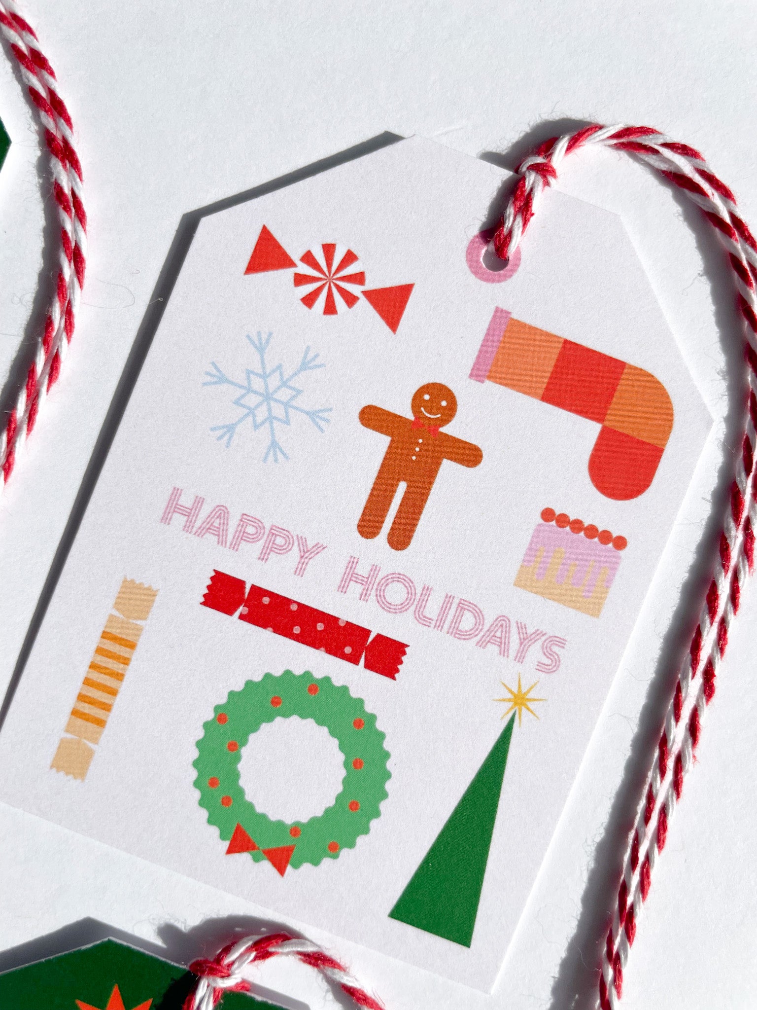 Christmas-themed gift tag with colorful illustrations and 'Happy Holidays' text on a white background. Seasons Greetings Gift Tag Set of 6