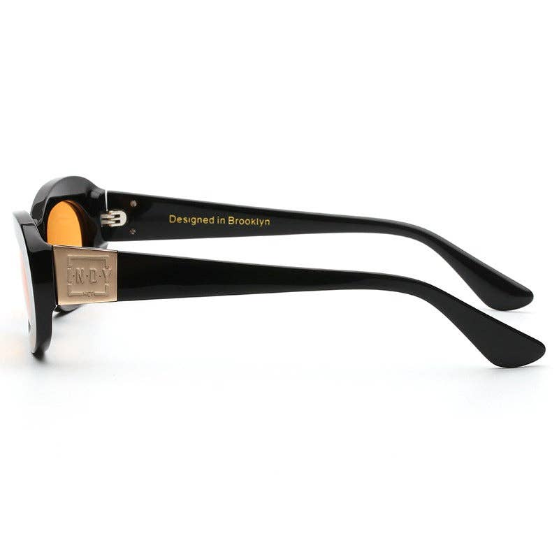 soho sunglasses Black sunglasses with gold accents on a white background