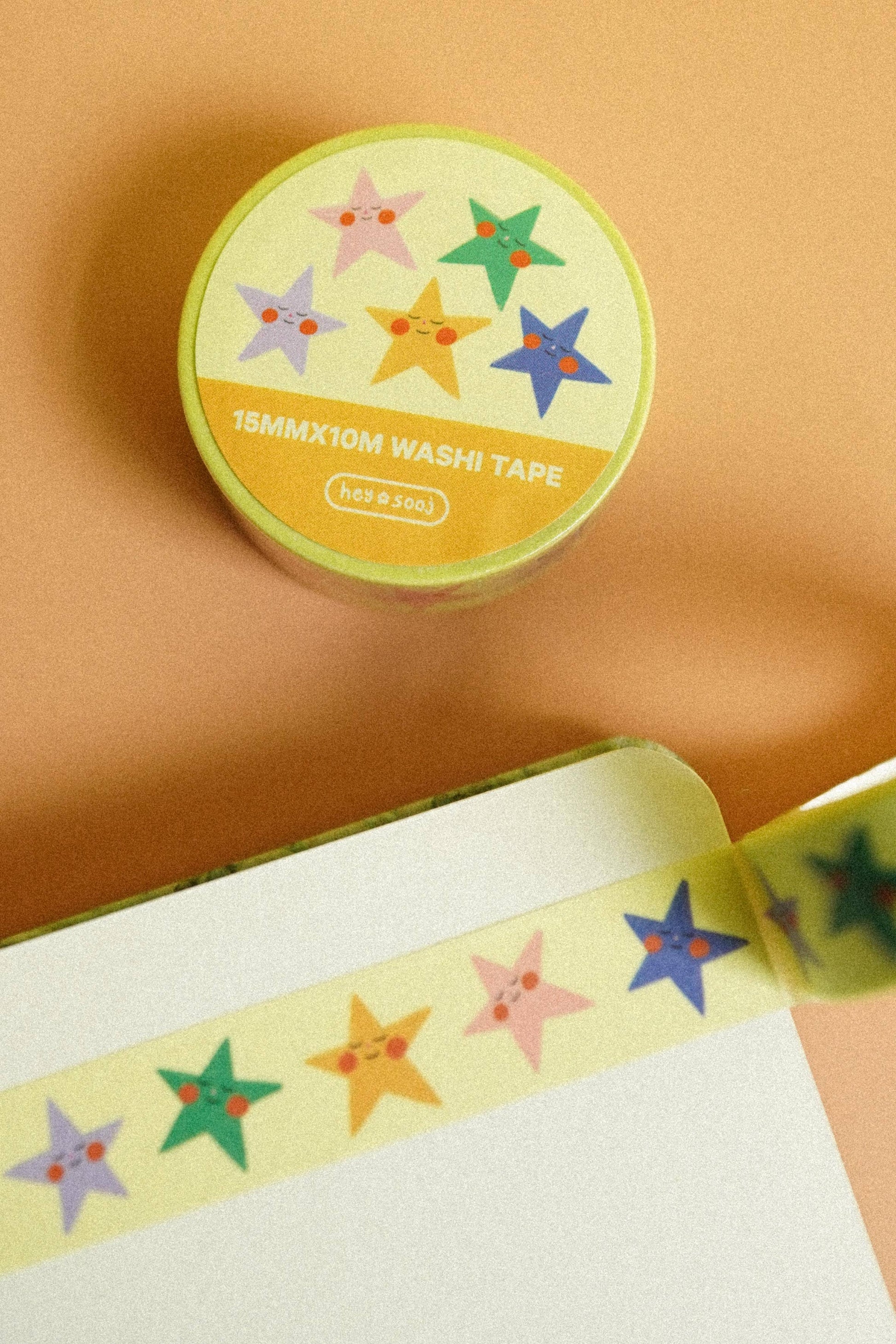 Washi tape with colorful star designs on a beige background, Stellar Washi Tape