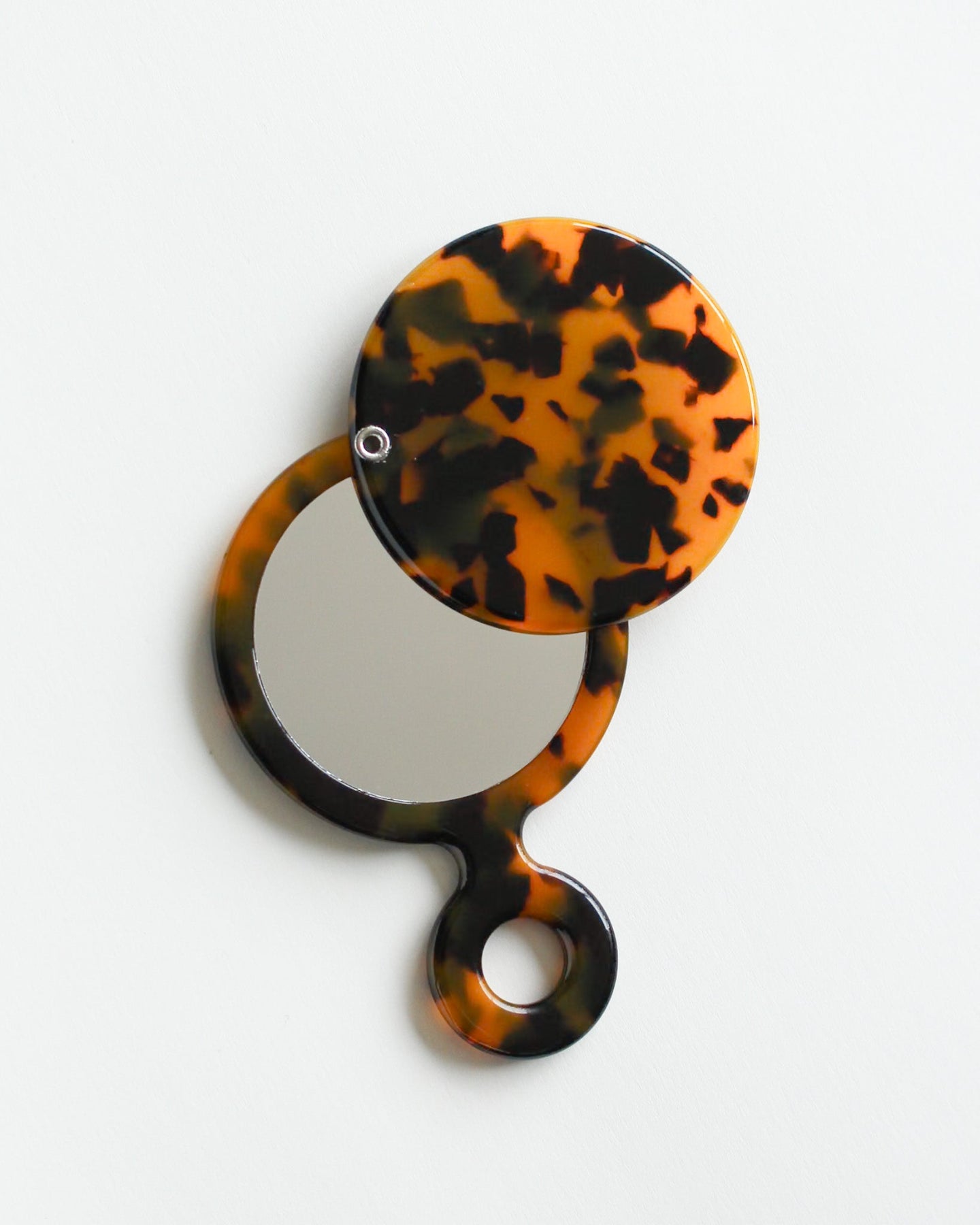 Swivel Pocket Mirror Tortoiseshell-patterned hand mirror on a white background