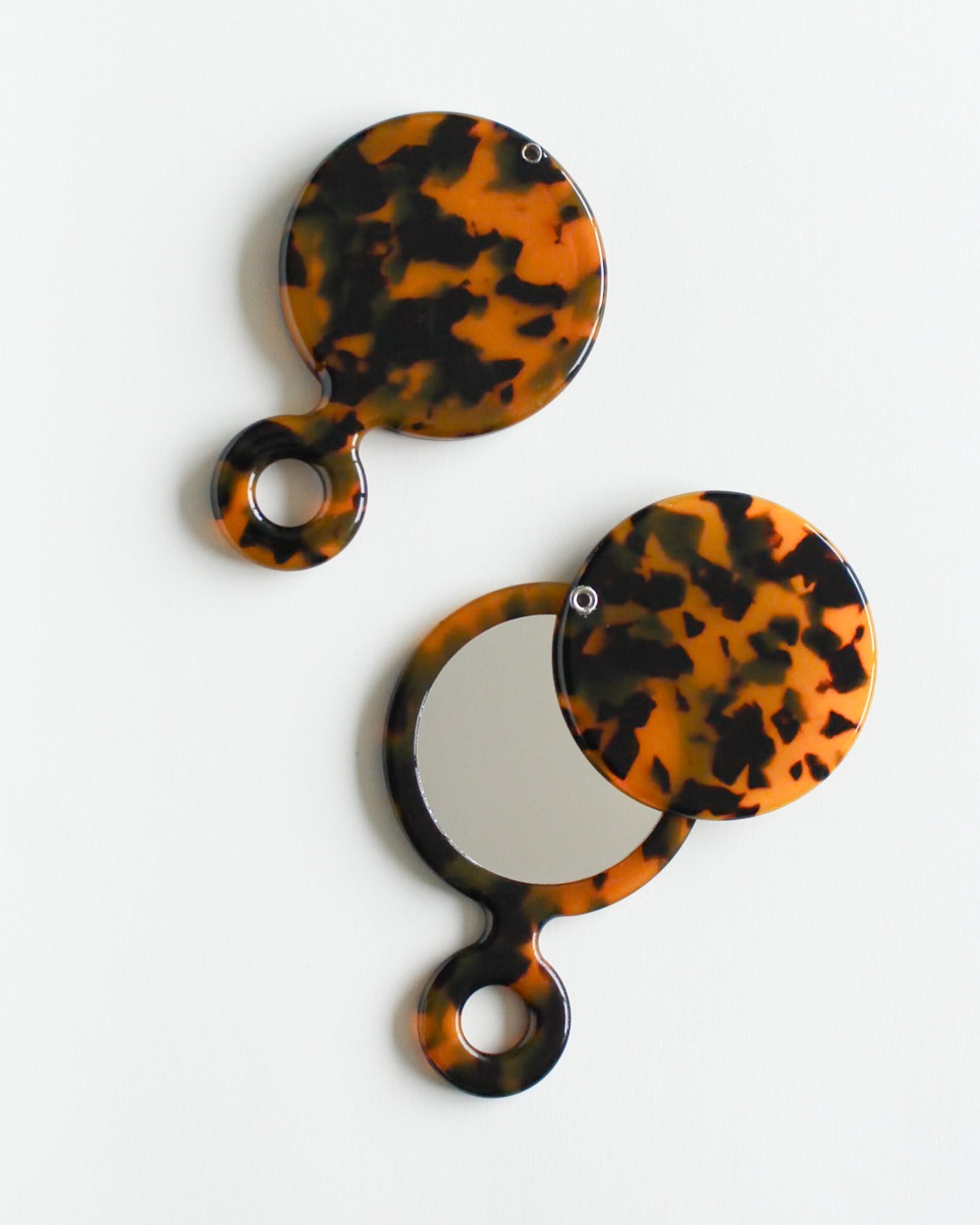 Swivel Pocket Mirror Tortoiseshell patterned hand mirrors on a white background