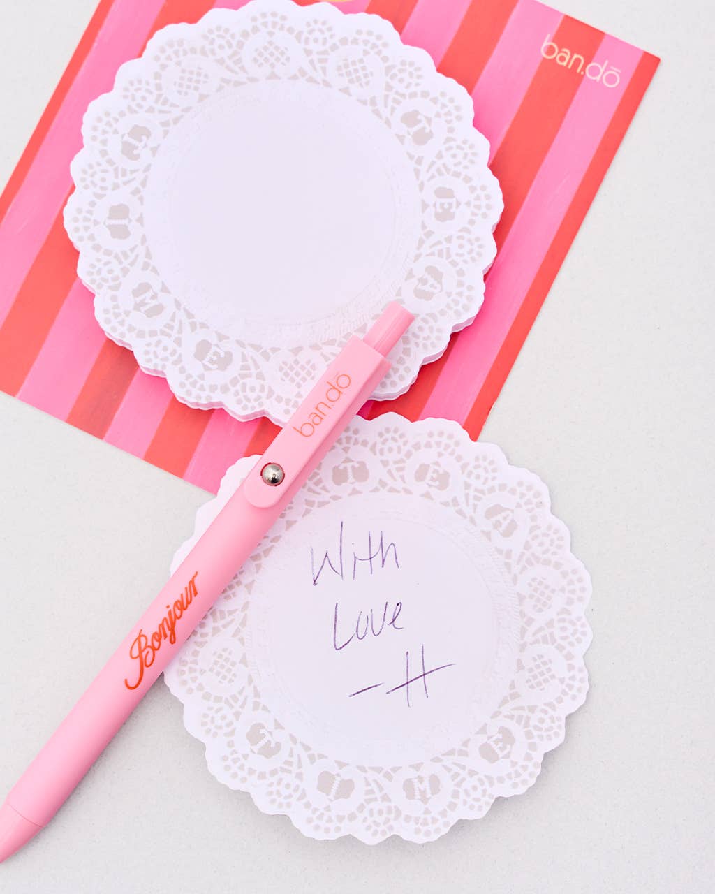 Pink pen with lace design on a pink and white striped background Tea_Time_Doily_Novelty_Notepad