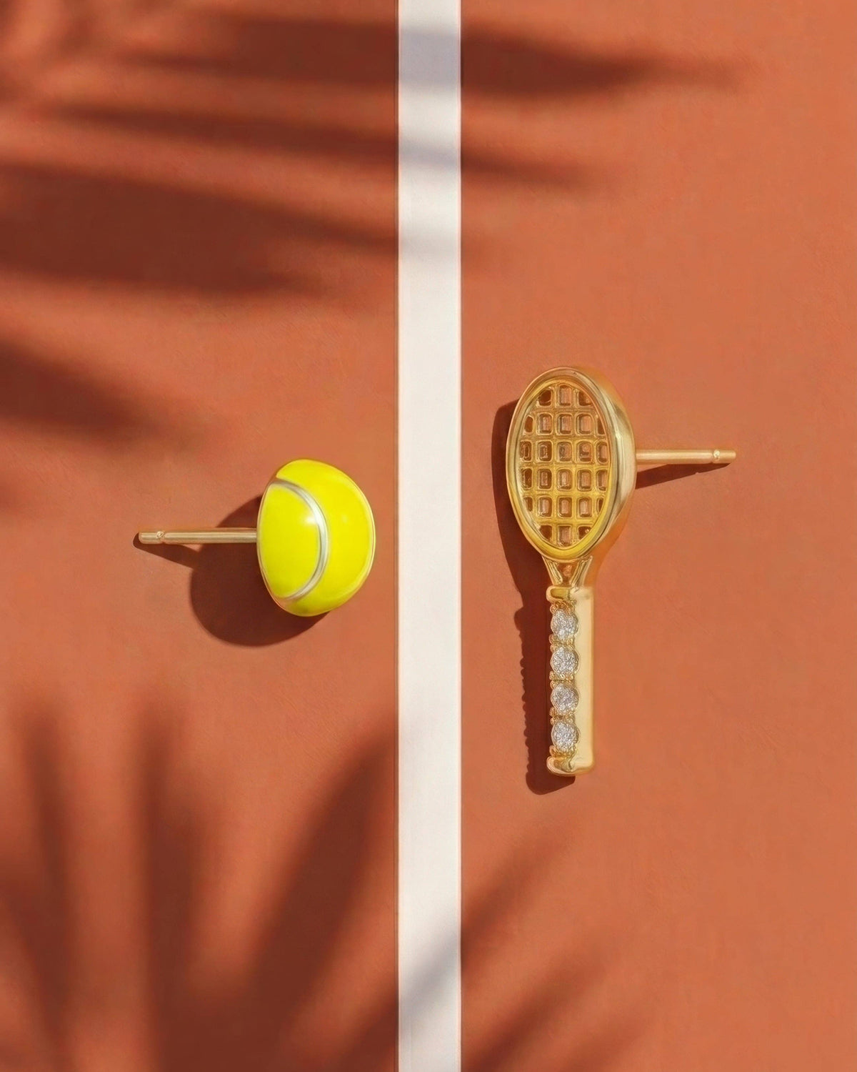 Tennis racket and ball earrings on a split brown background