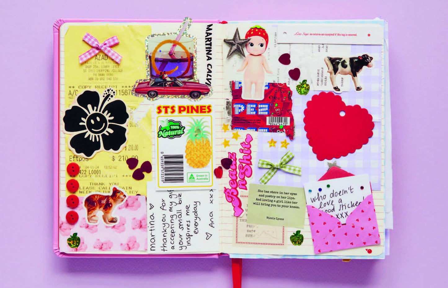 Open book with colorful stickers and paper cutouts on a purple background