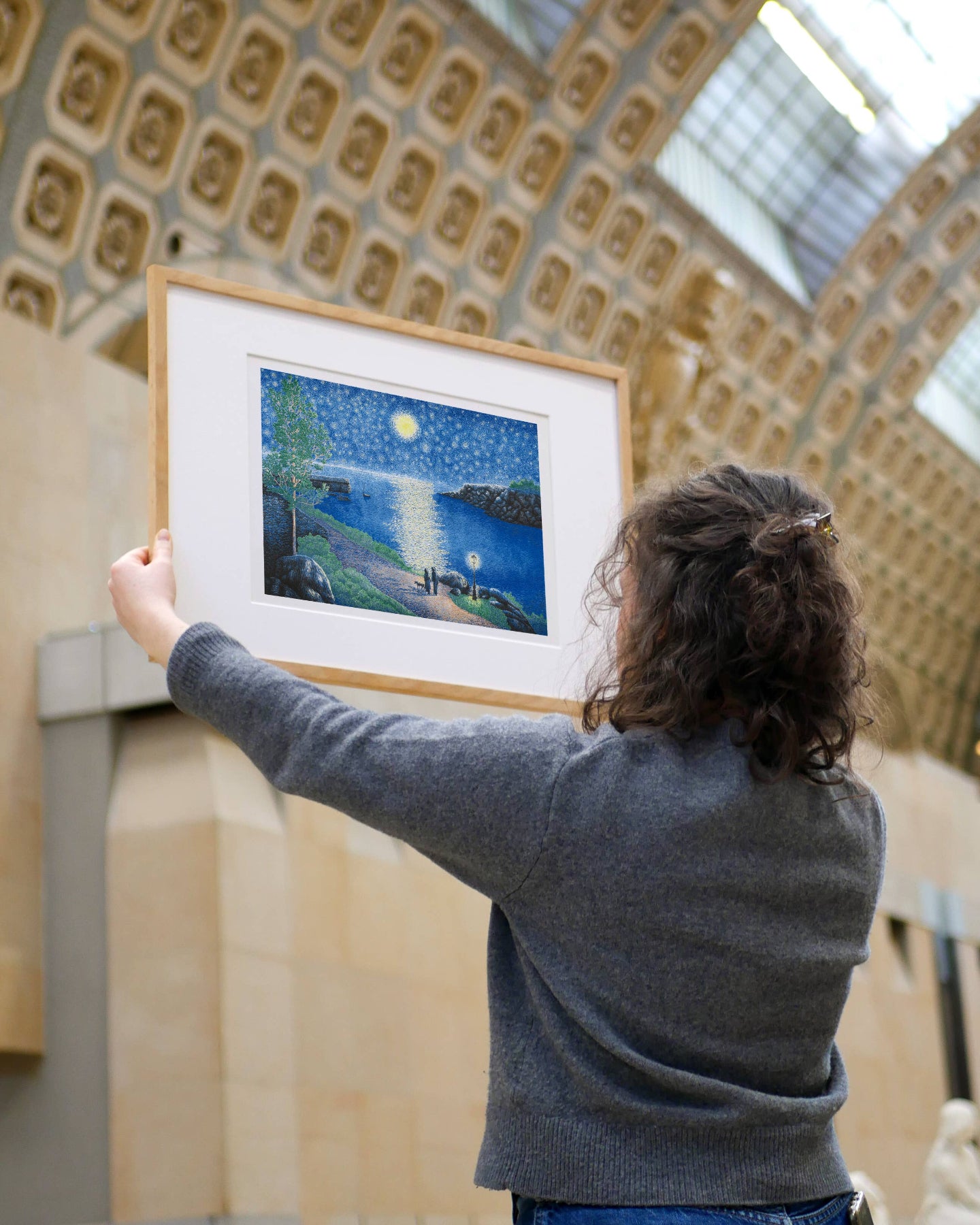 Person holding a framed artwork in a museum setting, The Starry Night Manon Diemer