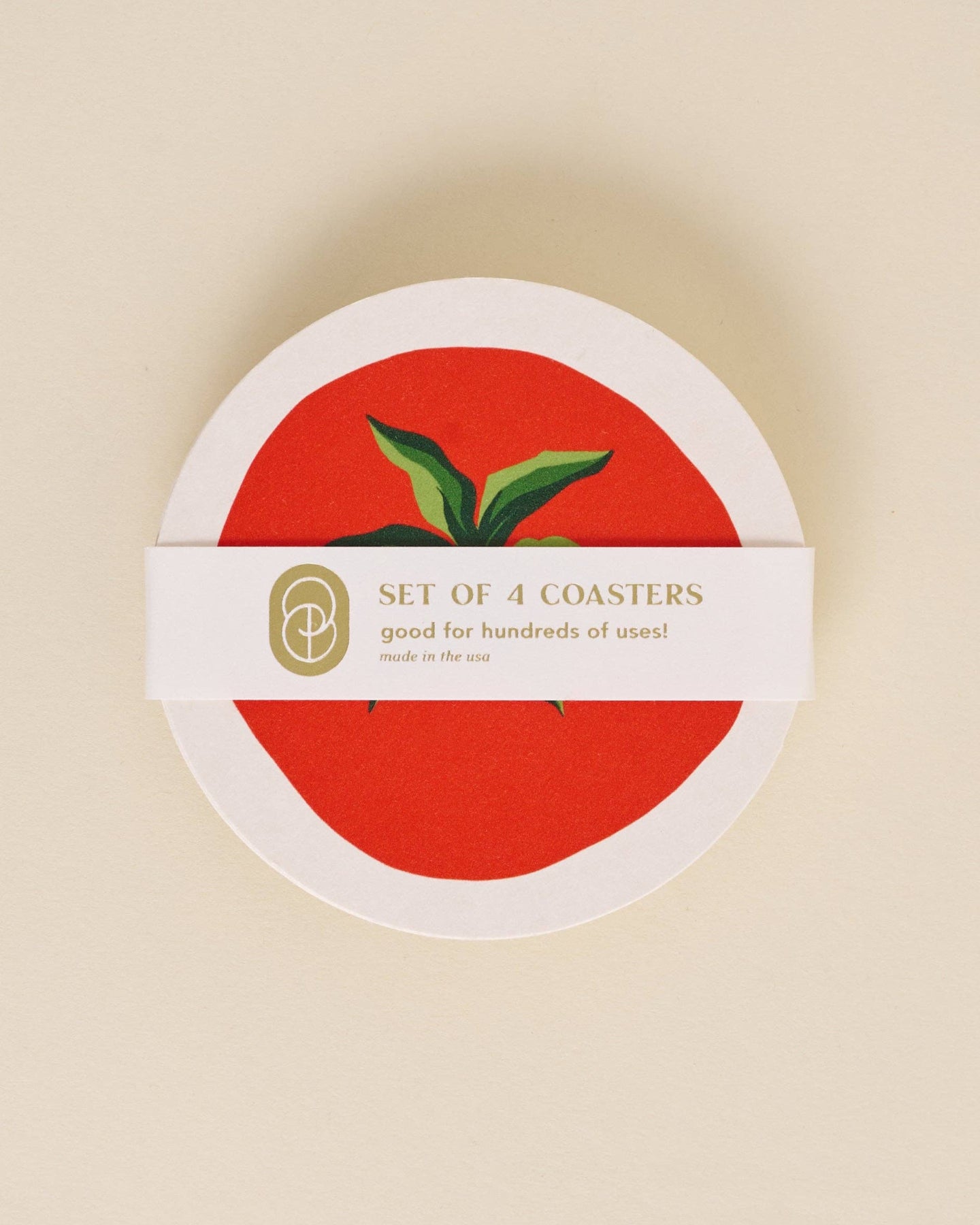 Set of 4 coasters with a red center and green leaves on a beige background
