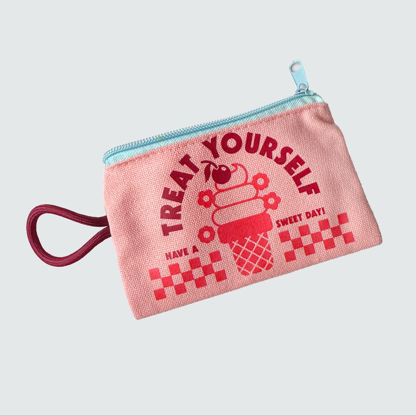 Pink pouch with red text and graphics on a light gray background
