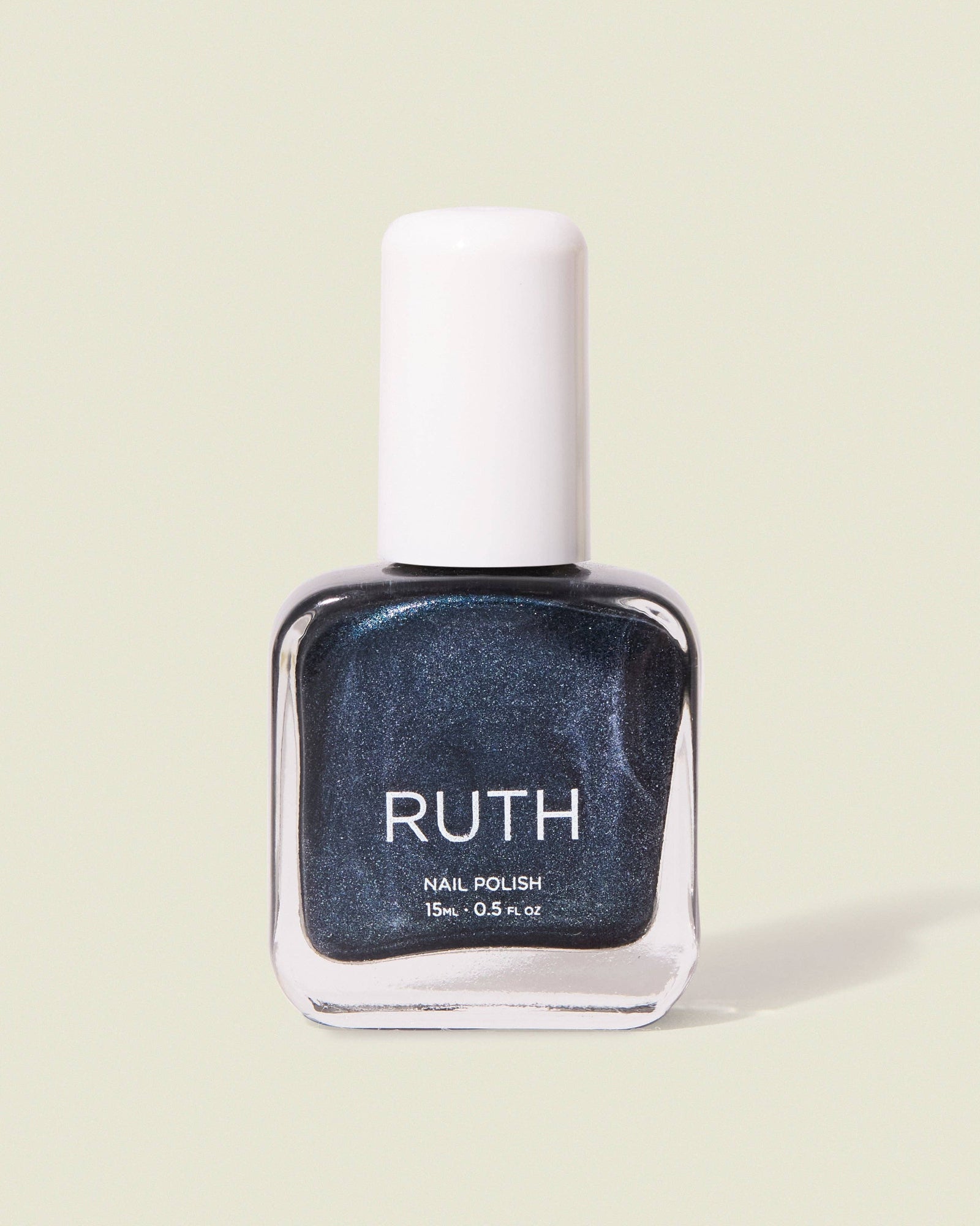 Nail polish bottle labeled 'RUTH' on a light green background, Twilight Metallic Grey Nail Polish Ruth Polish