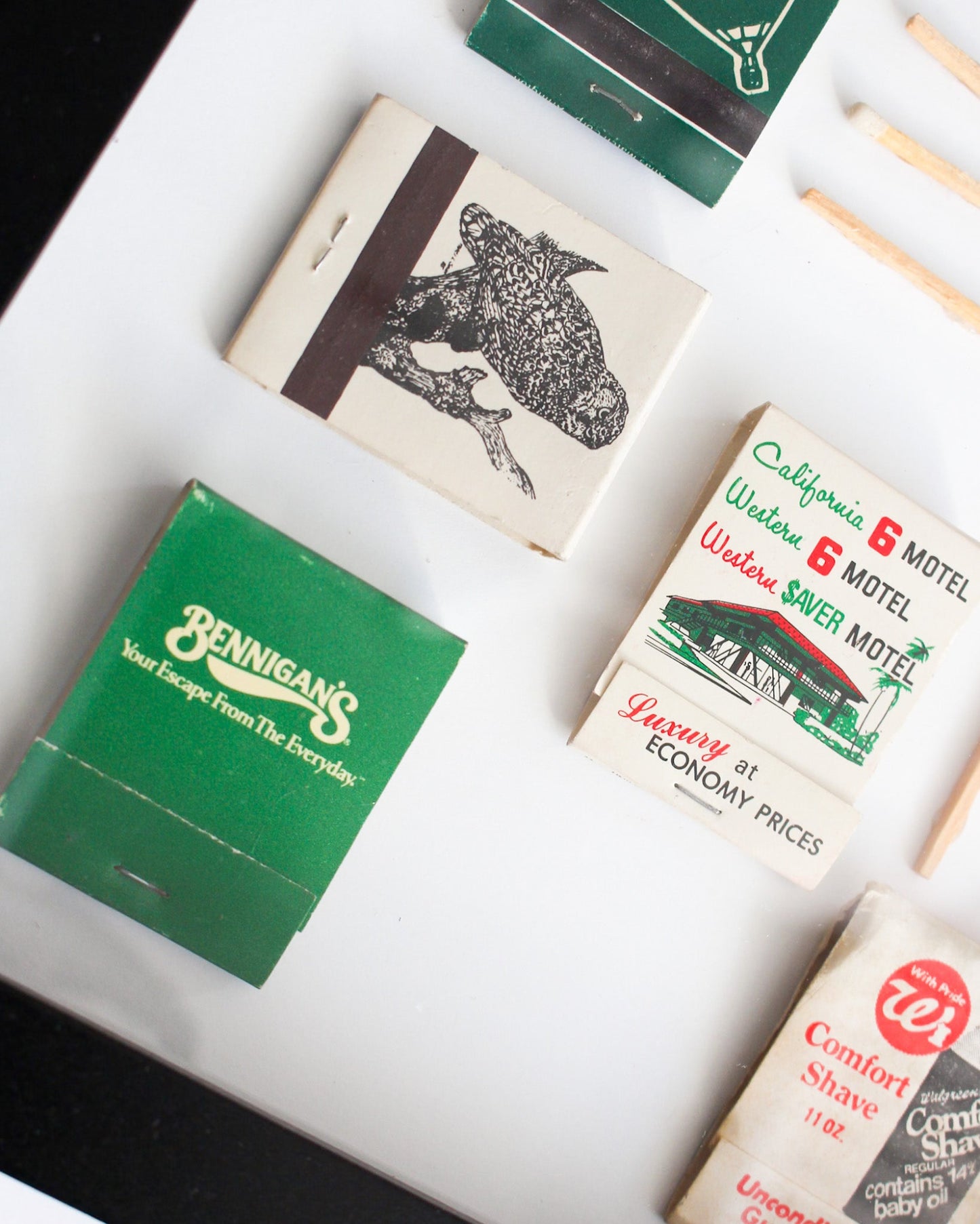 Collection of vintage matchbooks with different designs and branding.
