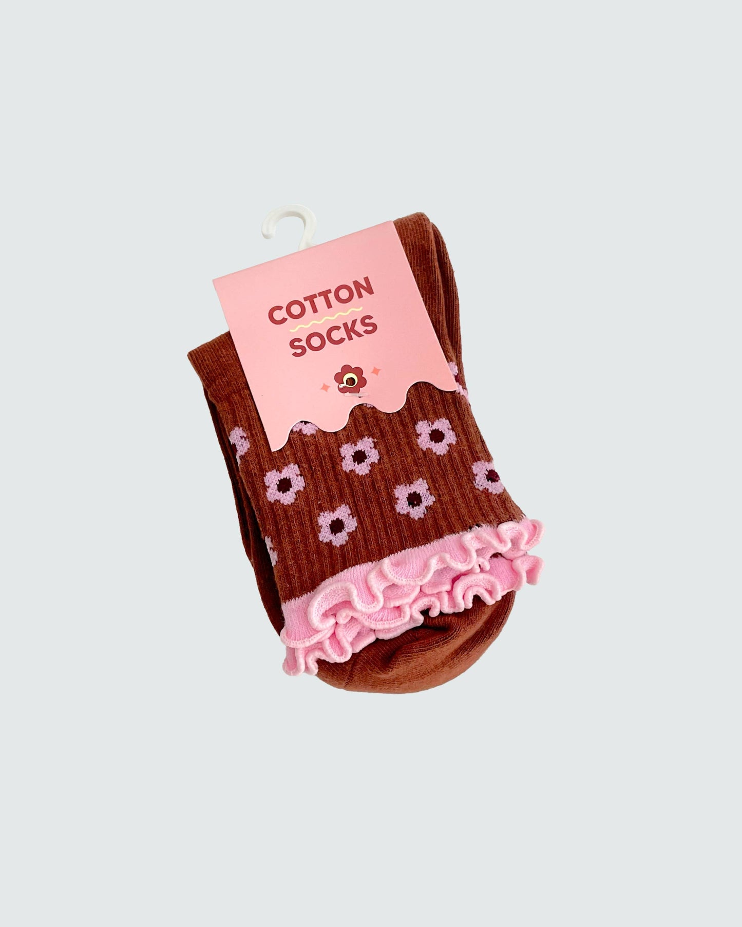 Brown socks with pink flowers and ruffles on a white background