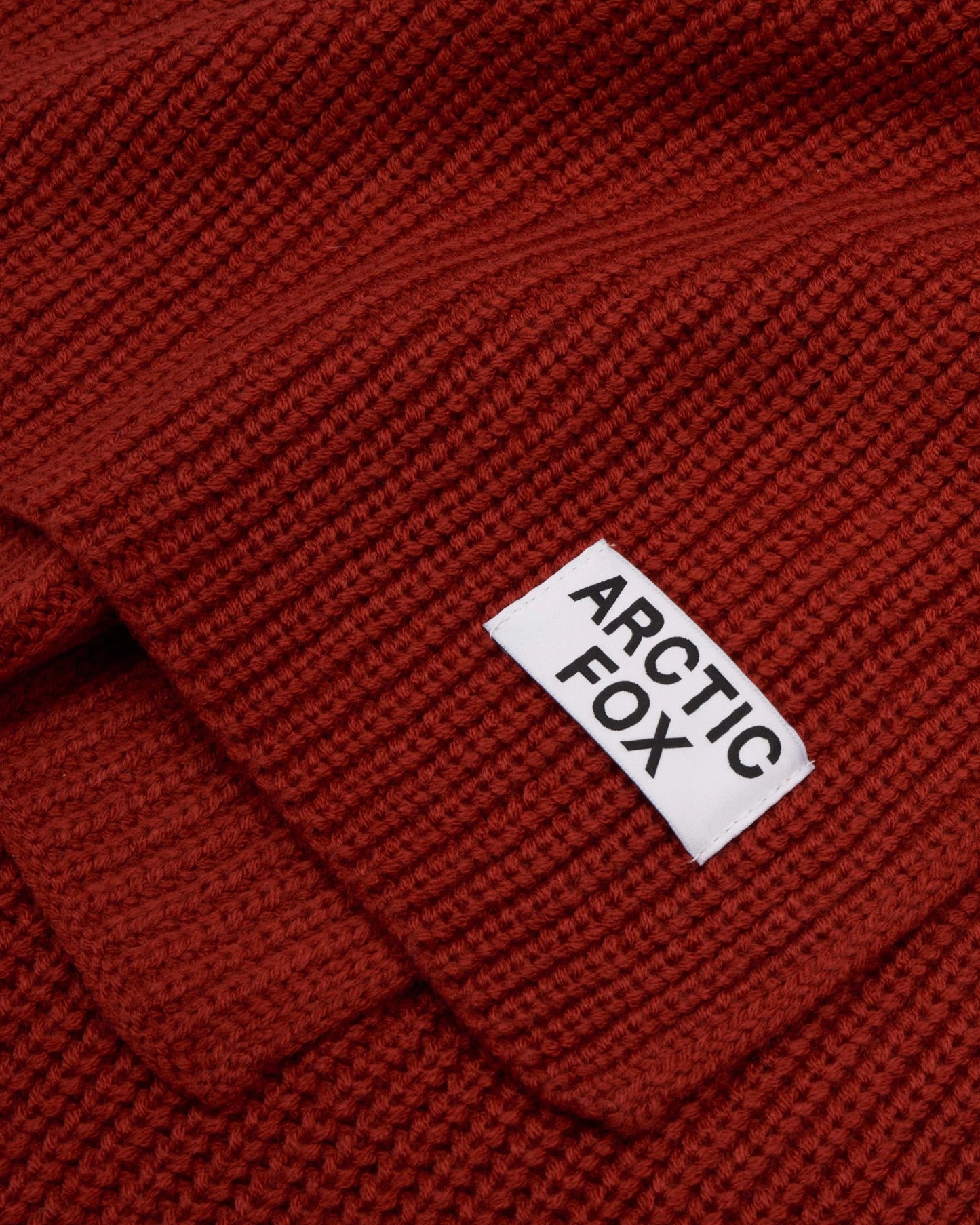 Red knitted fabric with 'Arctic Fox' label, Terracotta Knitted Recycled Bottle Scarf