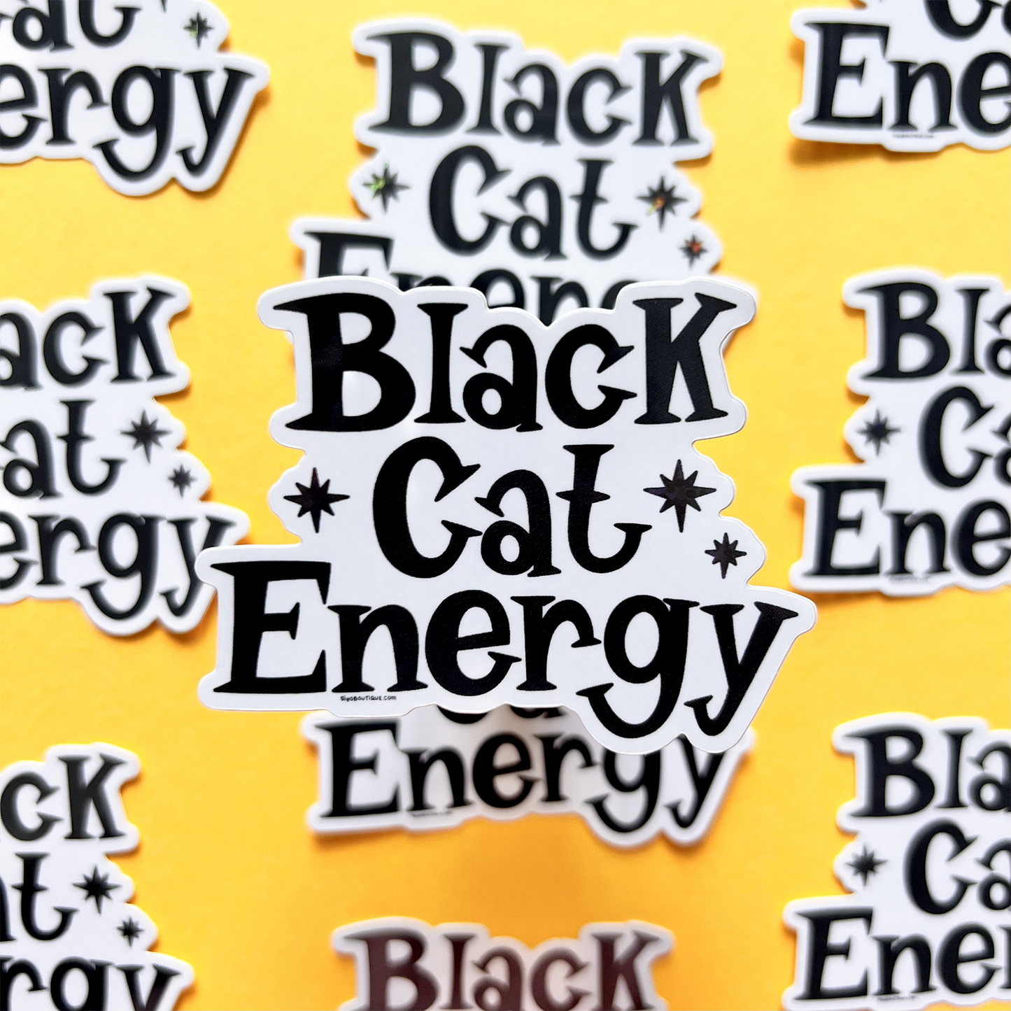 Stickers with 'Black Cat Energy' text on a yellow background