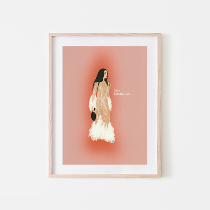 A framed fashion art print featuring a stylized illustration of a woman in a beige and white feathered dress against a dusty pink background, housed in a light wood frame with a white mat.