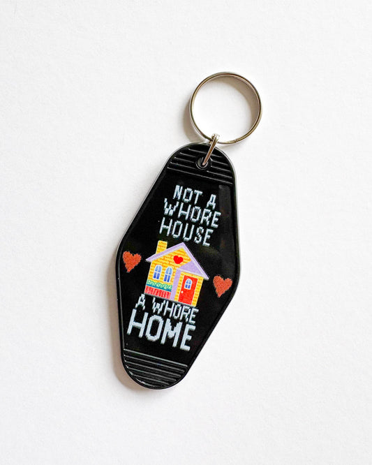 Keychain with a house illustration and text on a white background