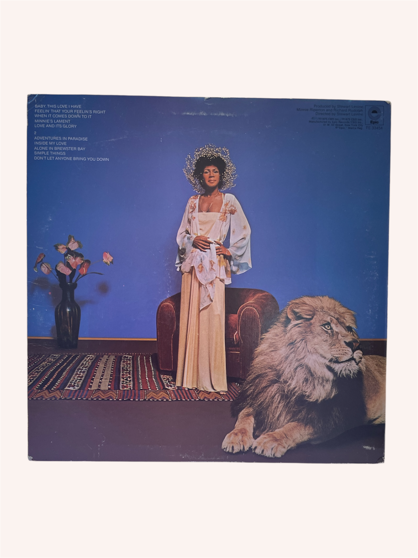 Vinyl record cover with a woman in a long dress and a lion on a blue, Adventures in Paradise Vinyl Record - Minnie Ripertonbackground