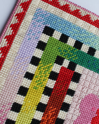 Close-up of a colorful woven textile with geometric patterns